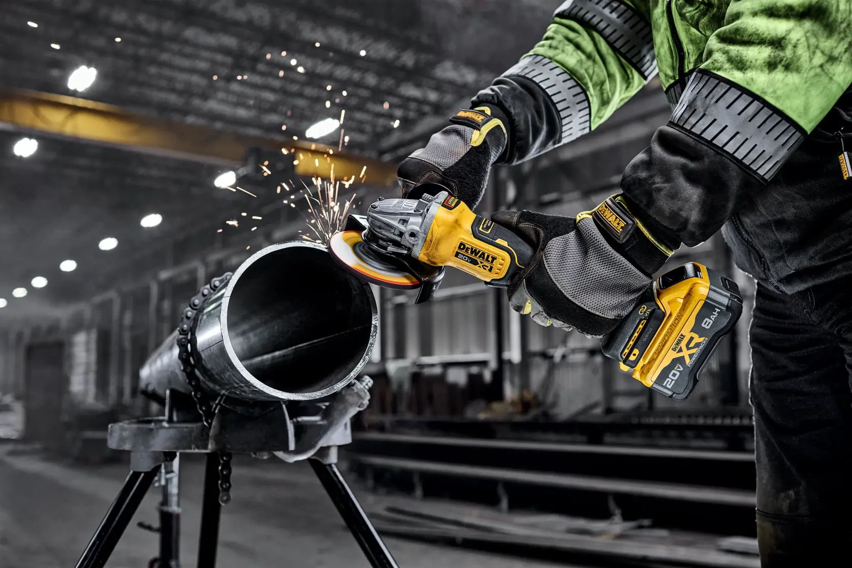 DEWALT 20V MAX* XR®  4-1/2 in. - 5 in. Variable Speed Angle Grinder grinding metal pipe in a commercial setting. 