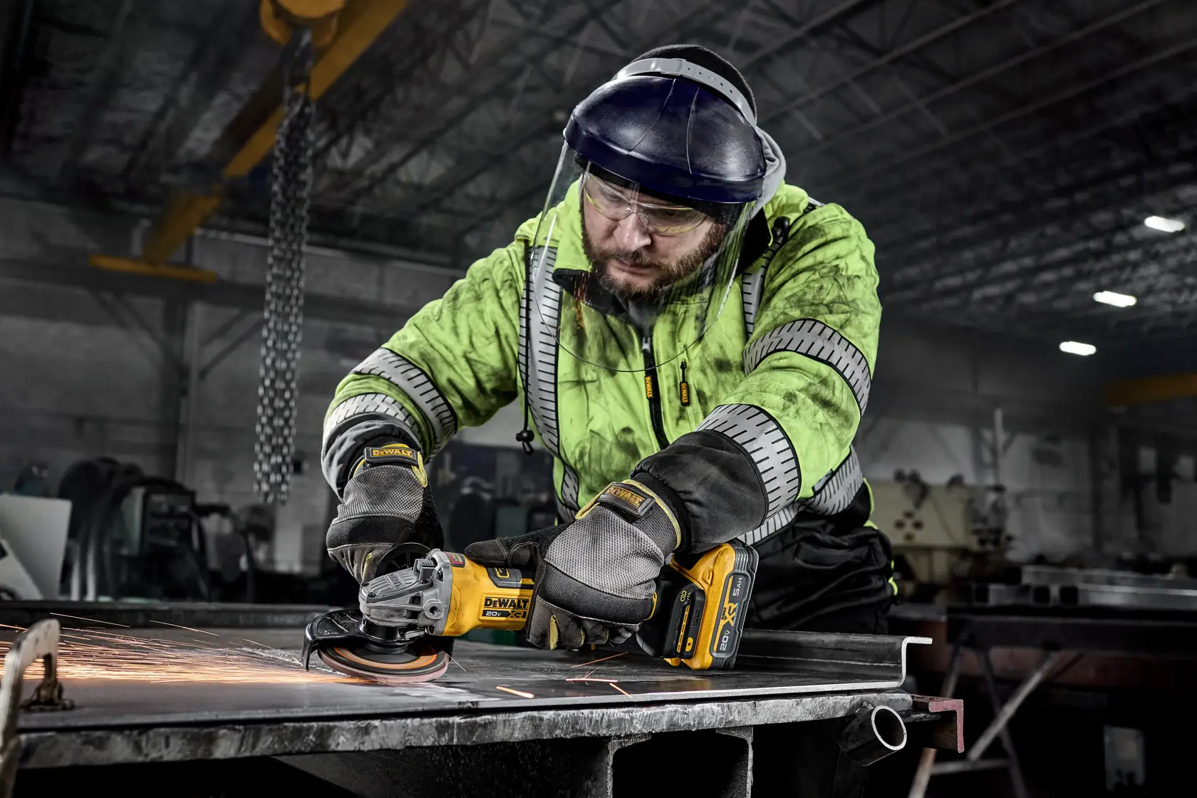 DEWALT 20V MAX* XR®  4-1/2 in. - 5 in. Variable Speed Angle Grinder grinding sheet metal in a commercial setting. 