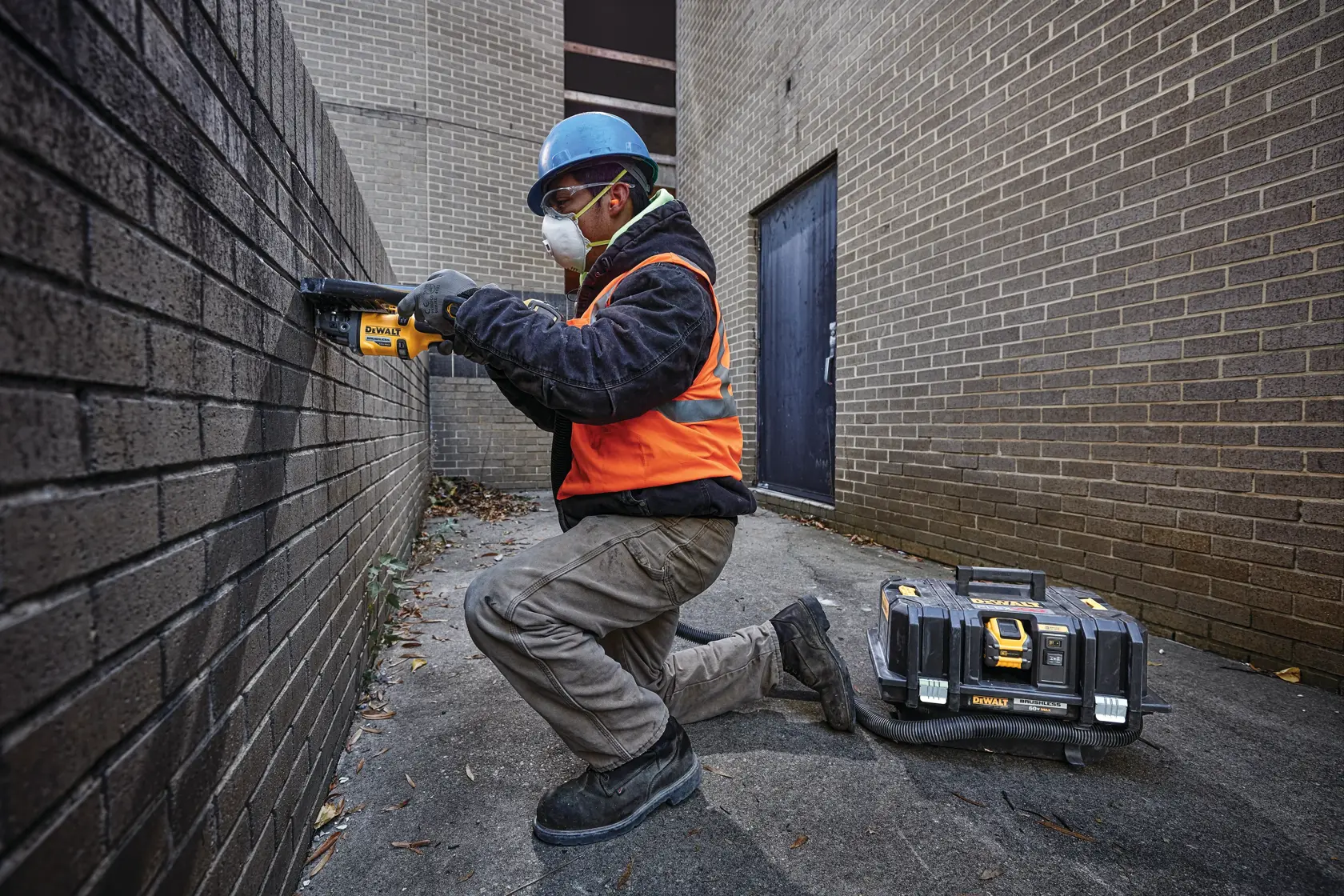 CORDLESS GRINDER WITH KICKBACK BRAKE being used by a workman on a wall