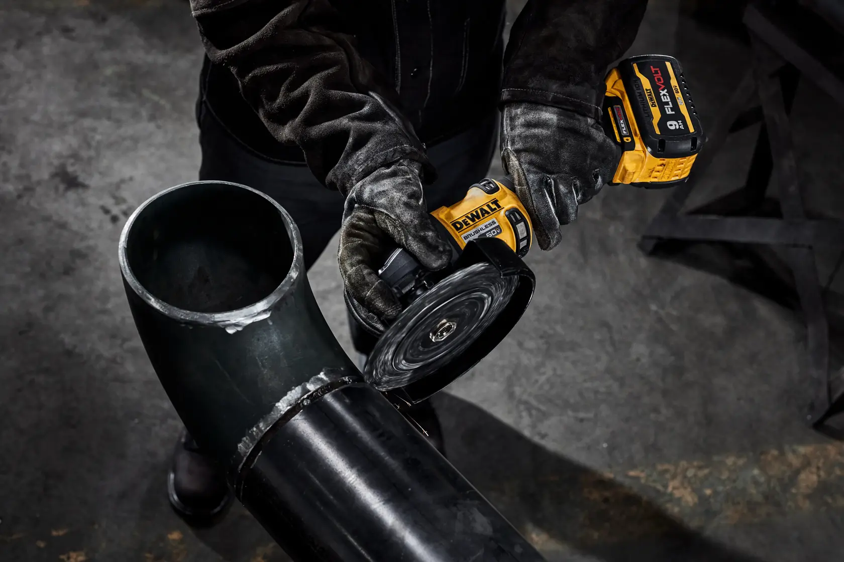 7 INCH BRUSHLESS CORDLESS GRINDER WITH KICK BACK BRAKE being used for cutting metal pipe.
