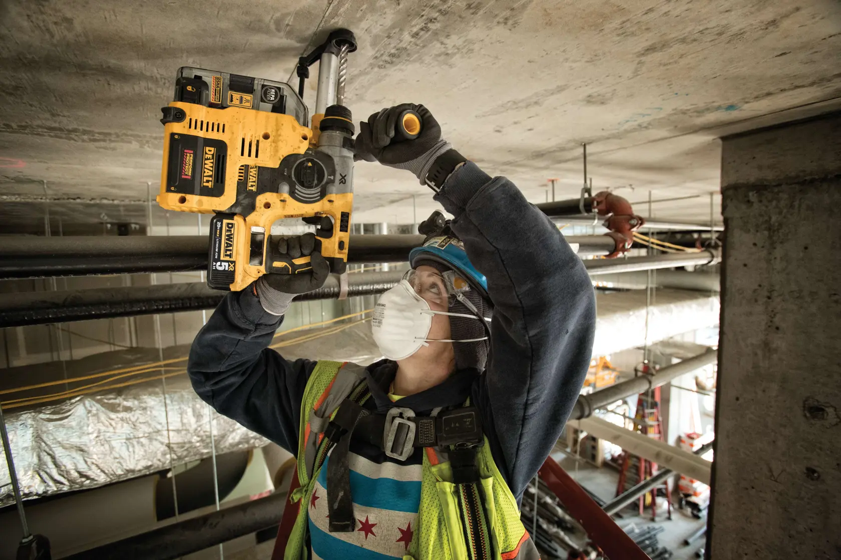 Brushless L-Shape SDS Plus rotary hammer with on-board dust extractor being used by a person
