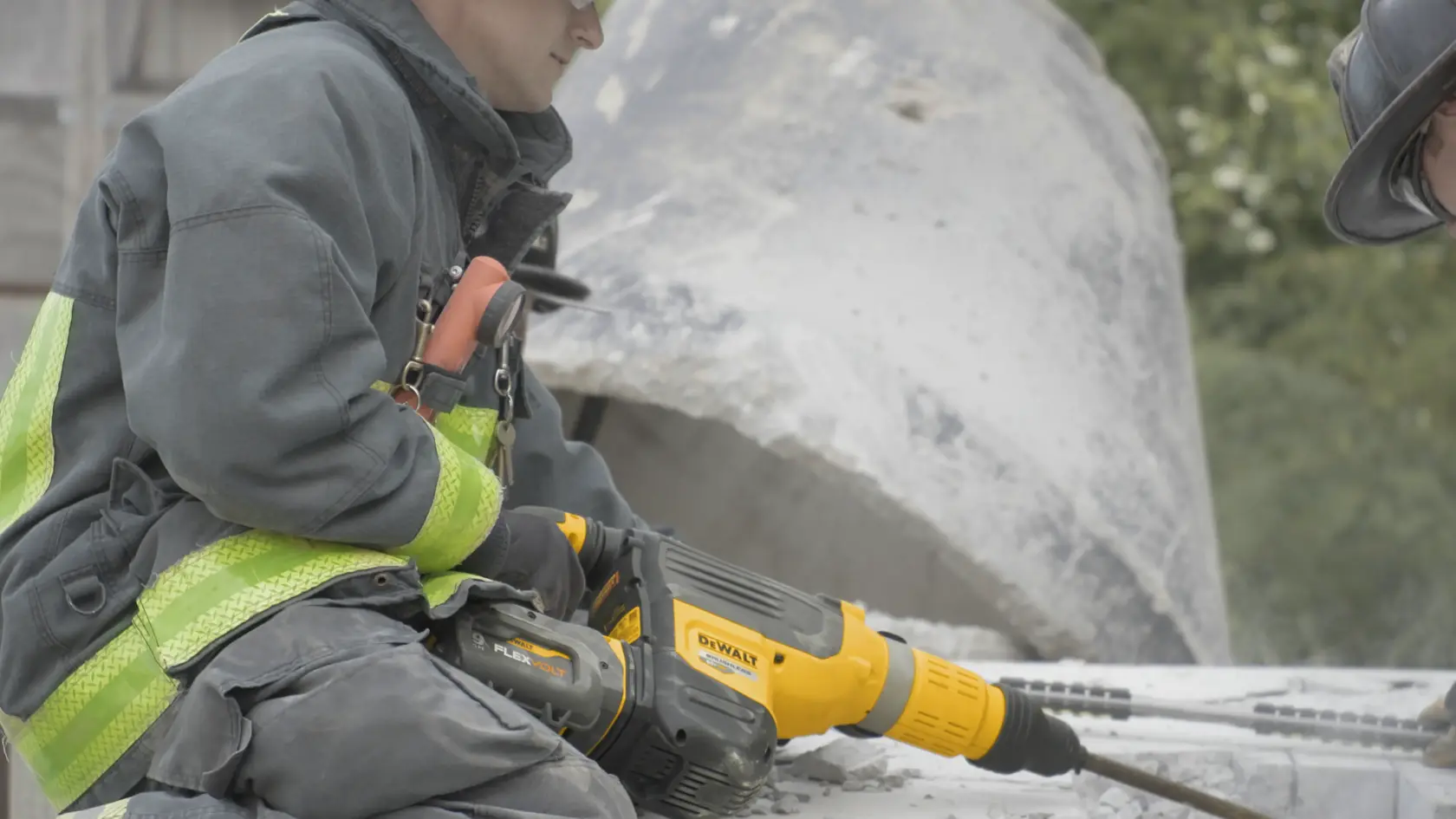 Image of Fire Fighter holding DeWalt 2 In Brushless Cordless Combination Rotary Hammer