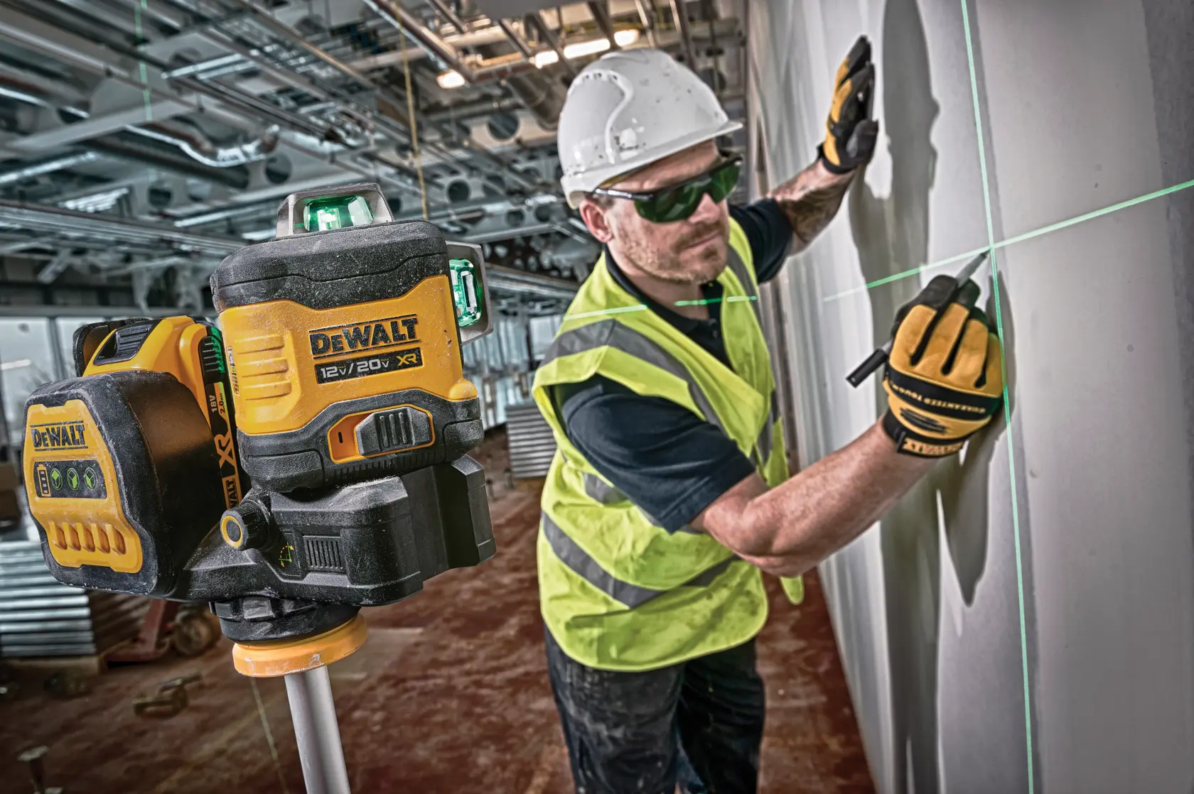 green line laser being used by a construction worker to make markings