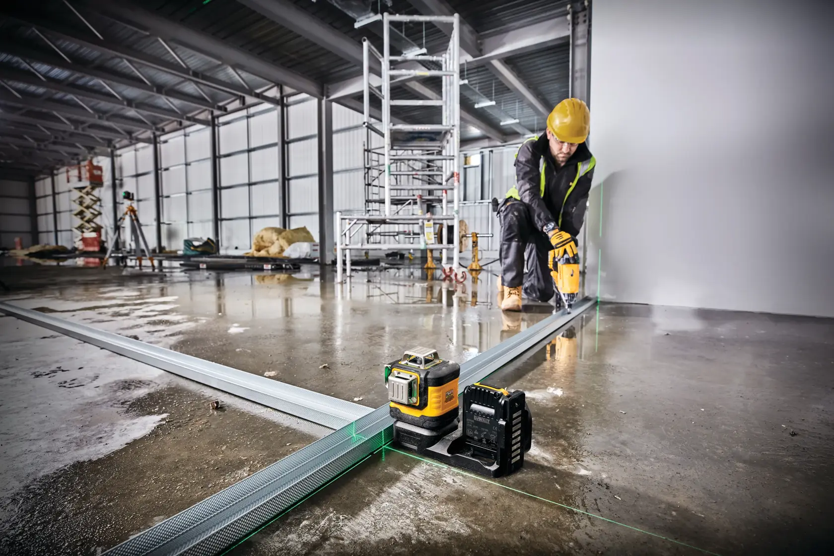 green line laser being used by a construction worker at a construction site