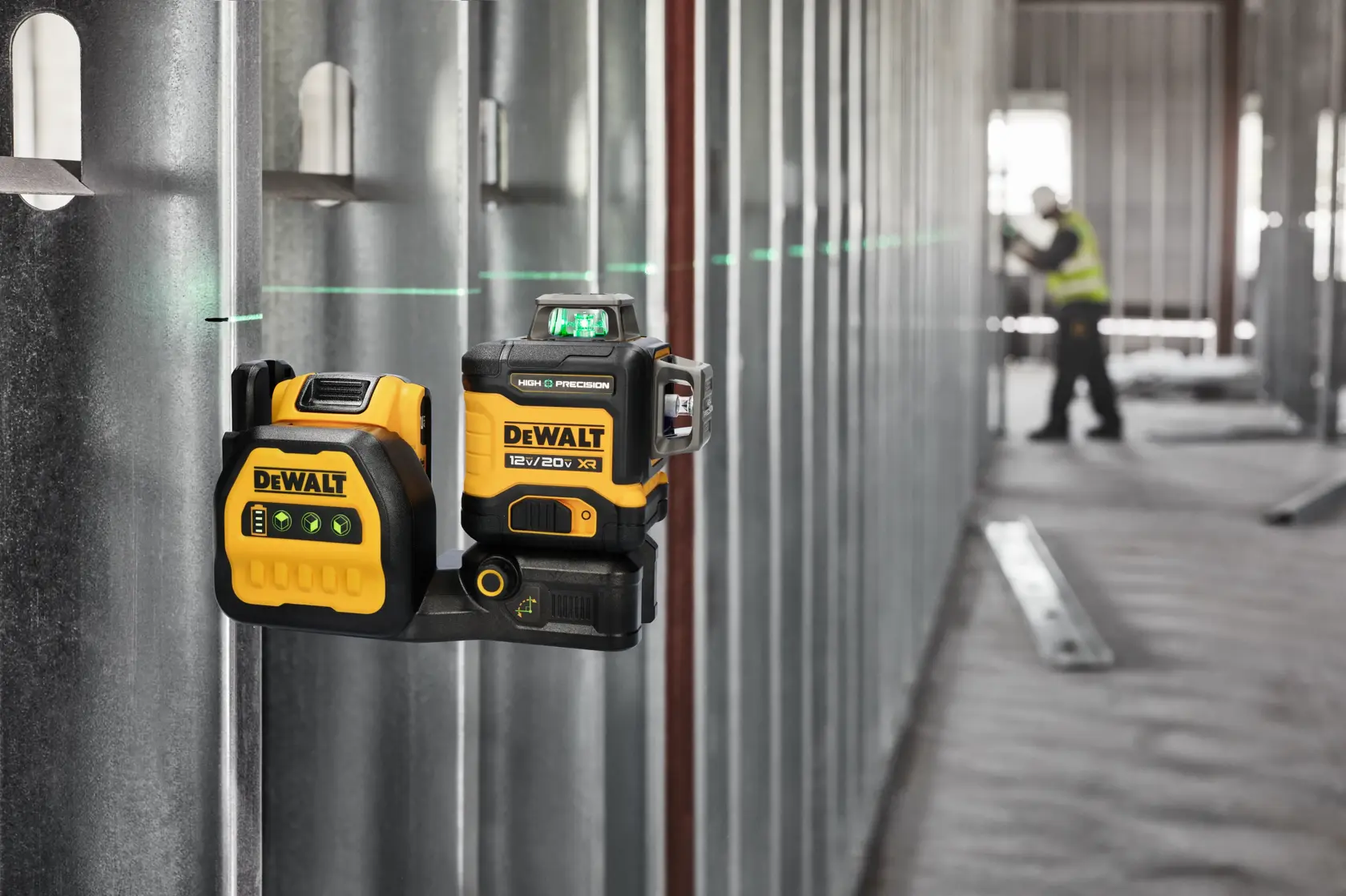 High Precision Laser hanging on a Metal Rail with a person measuring in the background. 