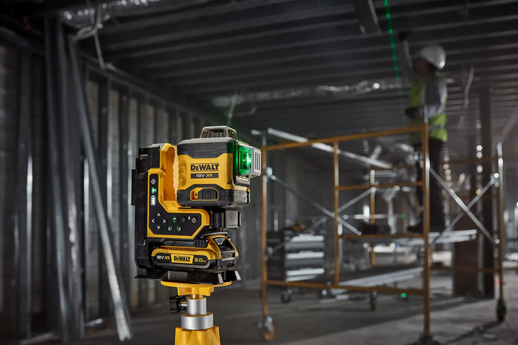 The 18V 3X 360 Remote Control Laser attached to tripod with its magnetic bracket, beam on ceiling