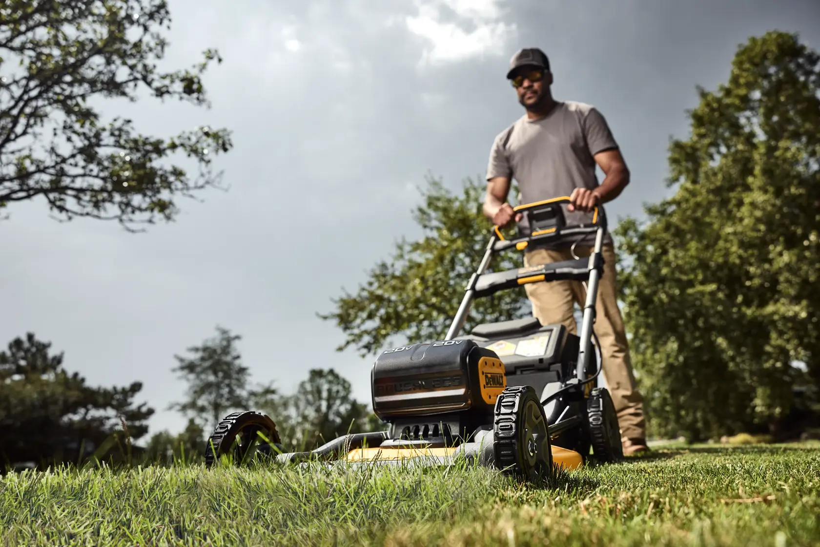 Landscaper pushing DEWALT XR Push Mower on lawn