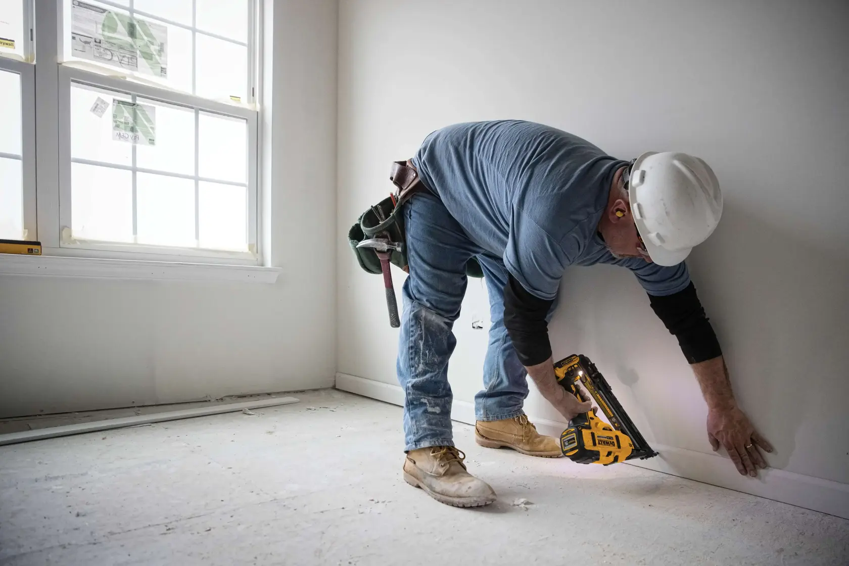 XR Cordless 15 Gauge Angled Finish Nailer in action by a construction worker at a construction site