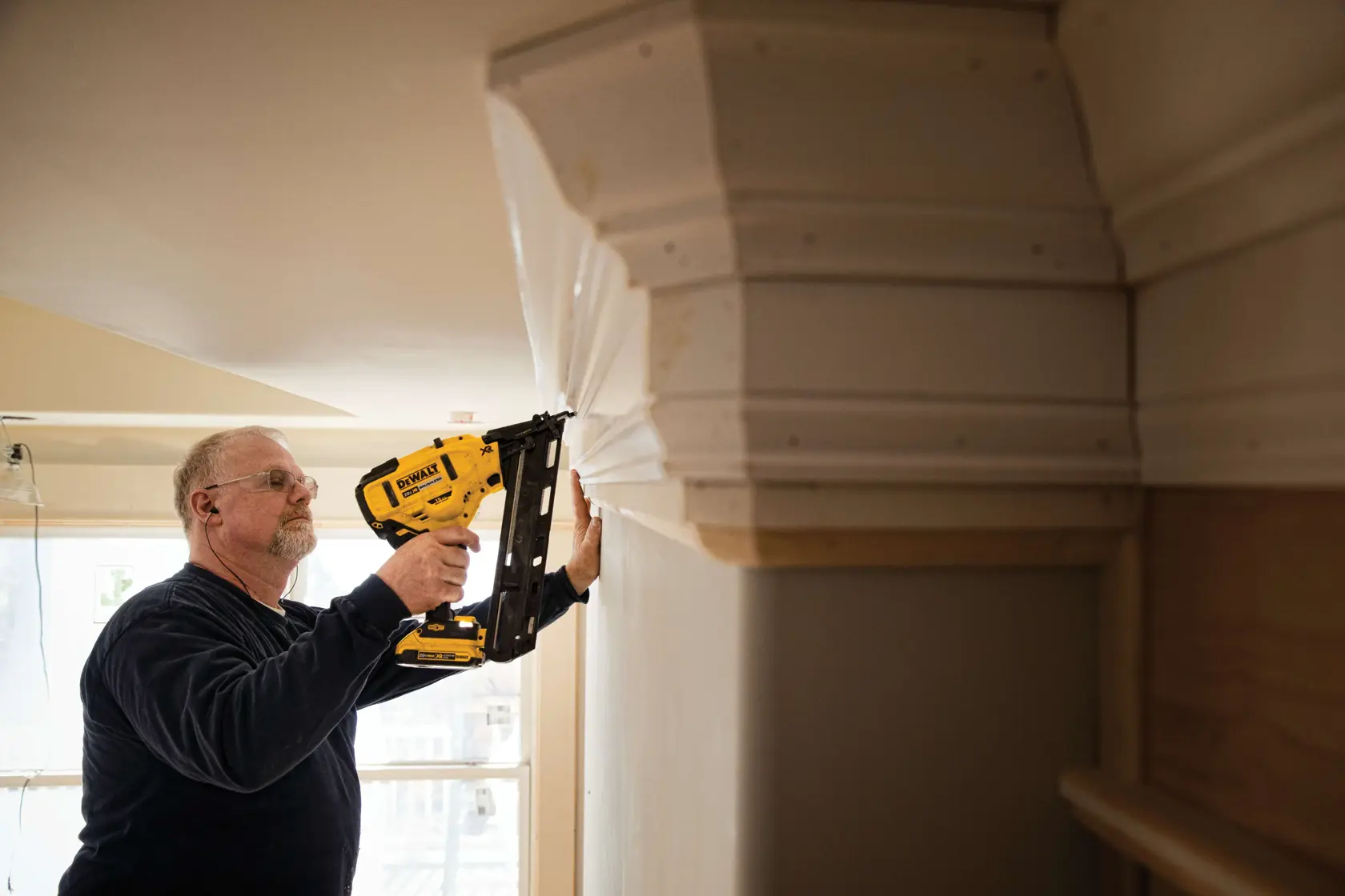 XR Cordless 15 Gauge Angled Finish Nailer in action by a construction worker at a construction site