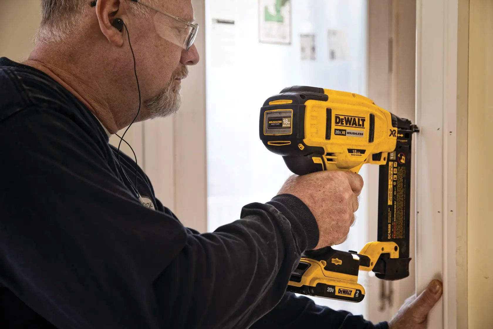 XR 18 GA Cordless Brad Nailer in action on a door frame by a construction worker