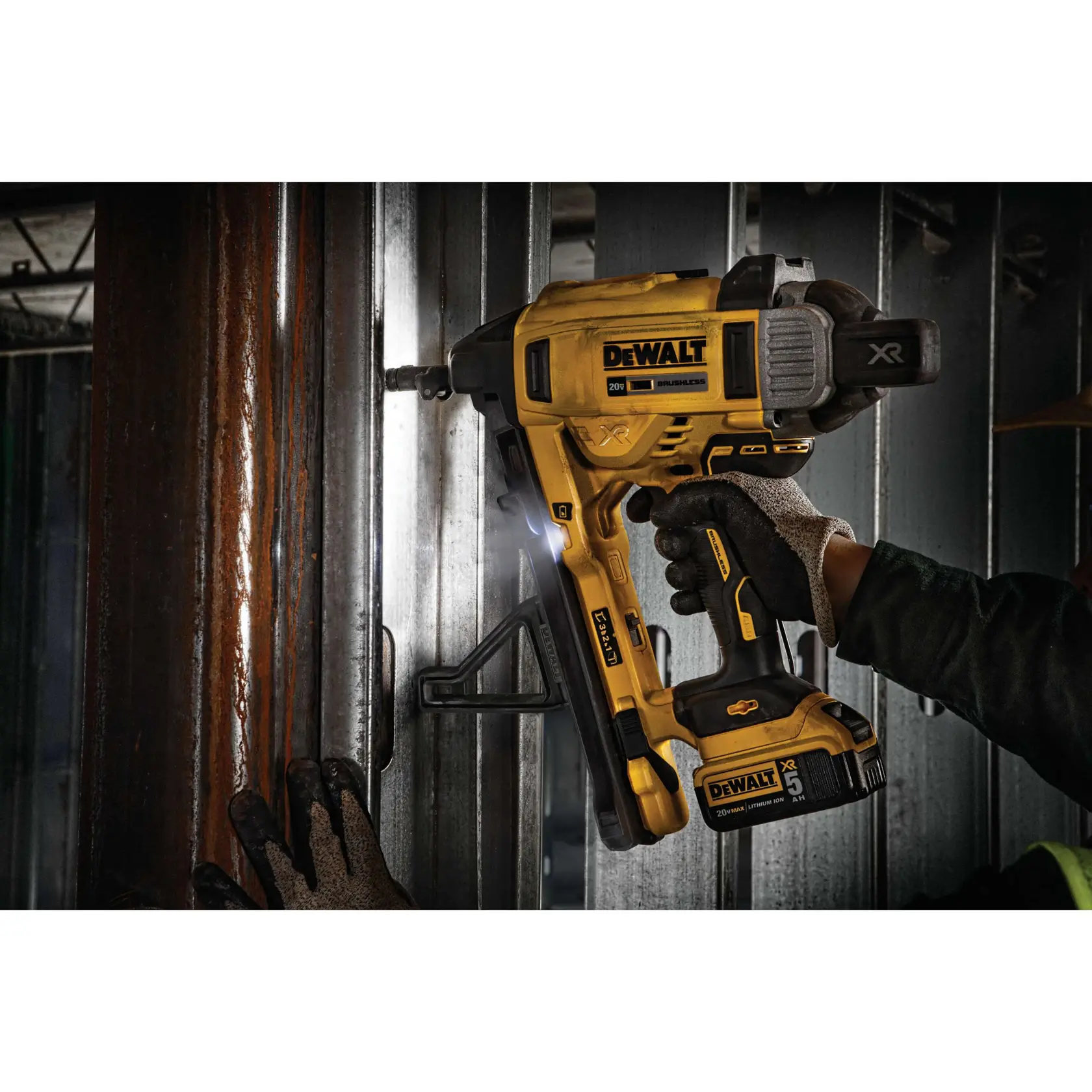 Magazine Cordless Concrete Nailer with a battery illuminating light on metallic surface.rn