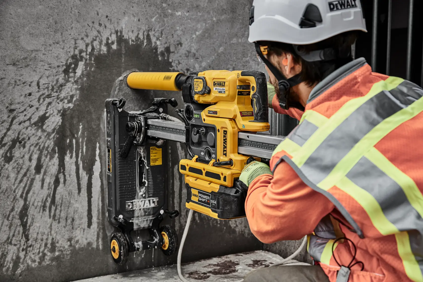 Man drilling hole in wall with core drill