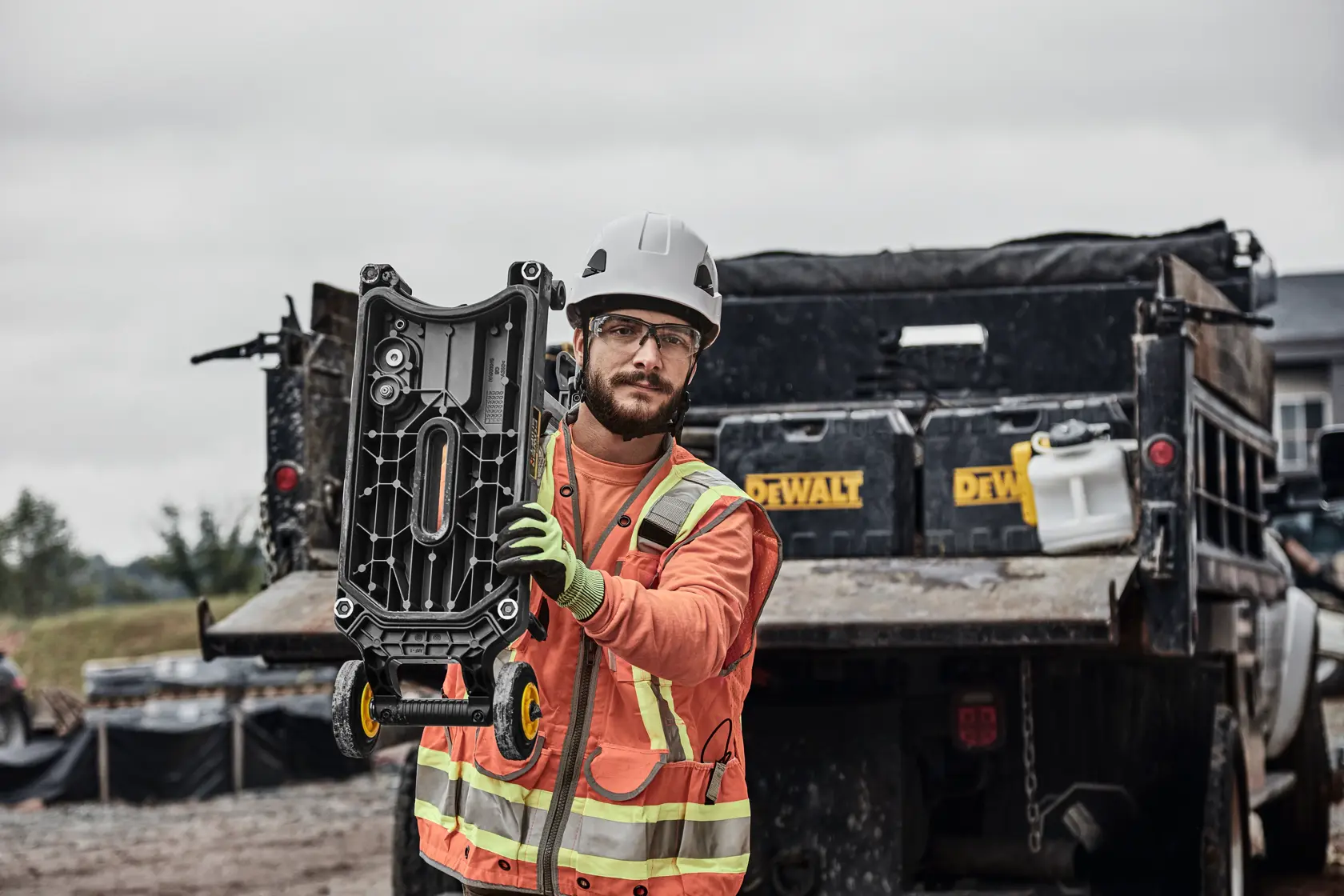Man carrying core drill stand 