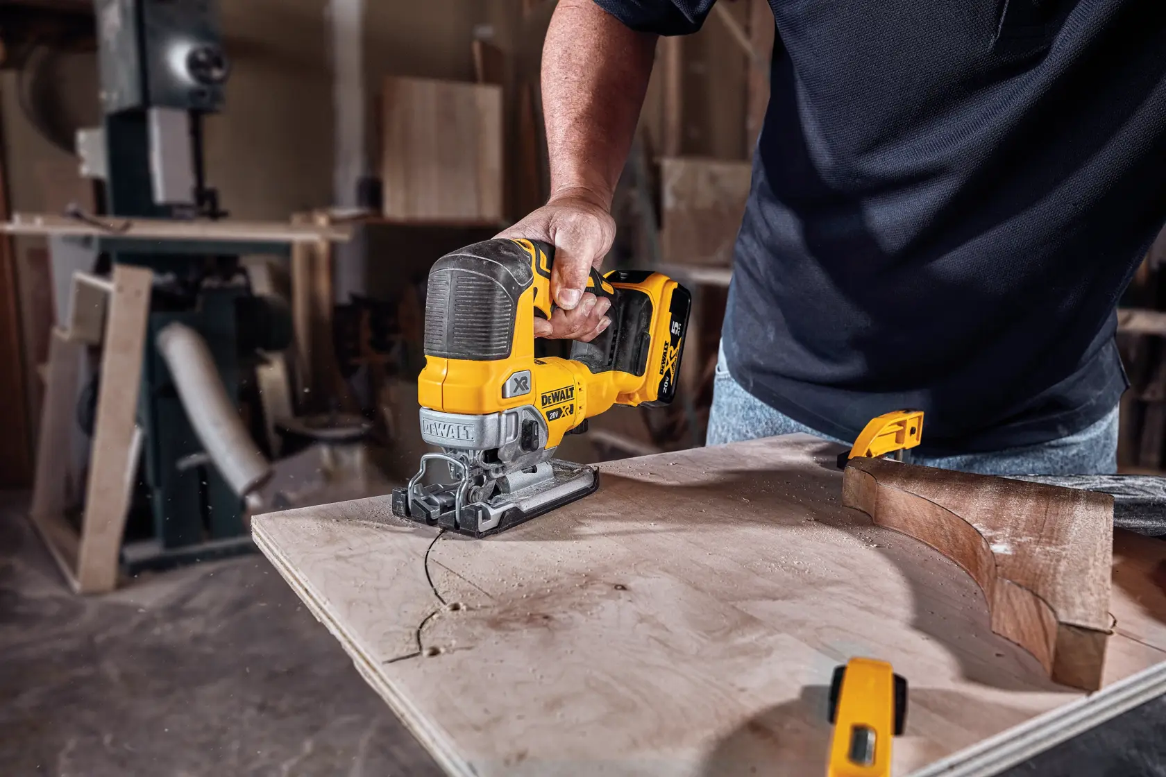 Cordless Jig Saw with battery cutting wood.
