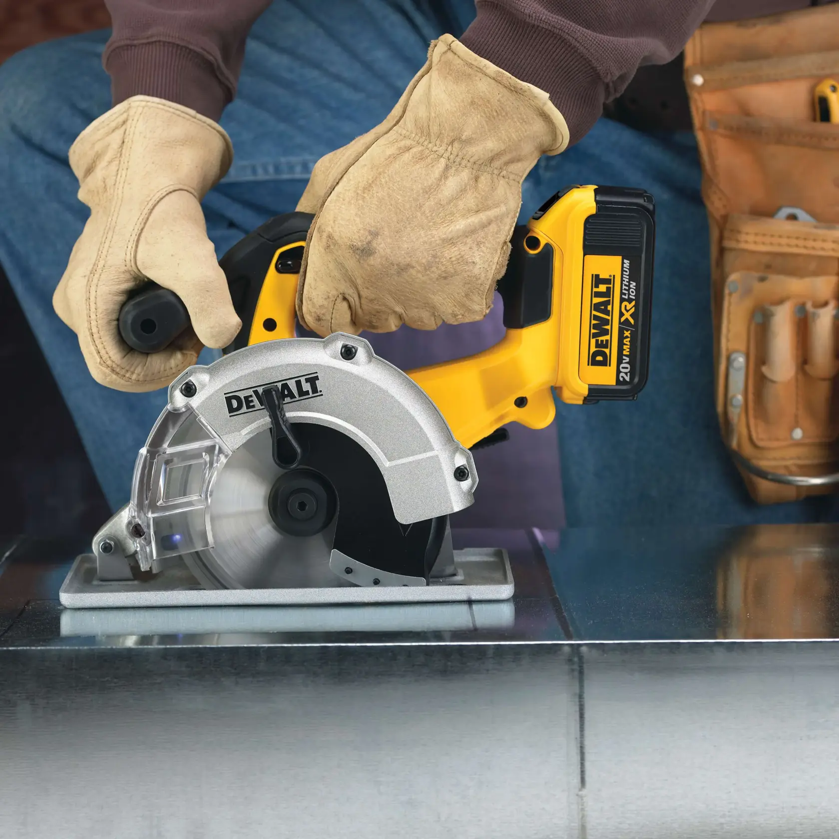 A close-up of gloved hands using a DEWALT cordless circular saw to cut a sheet of metal. The tool belt is visible on the side, and the saw is labeled 20V MAX XR Lithium Ion.