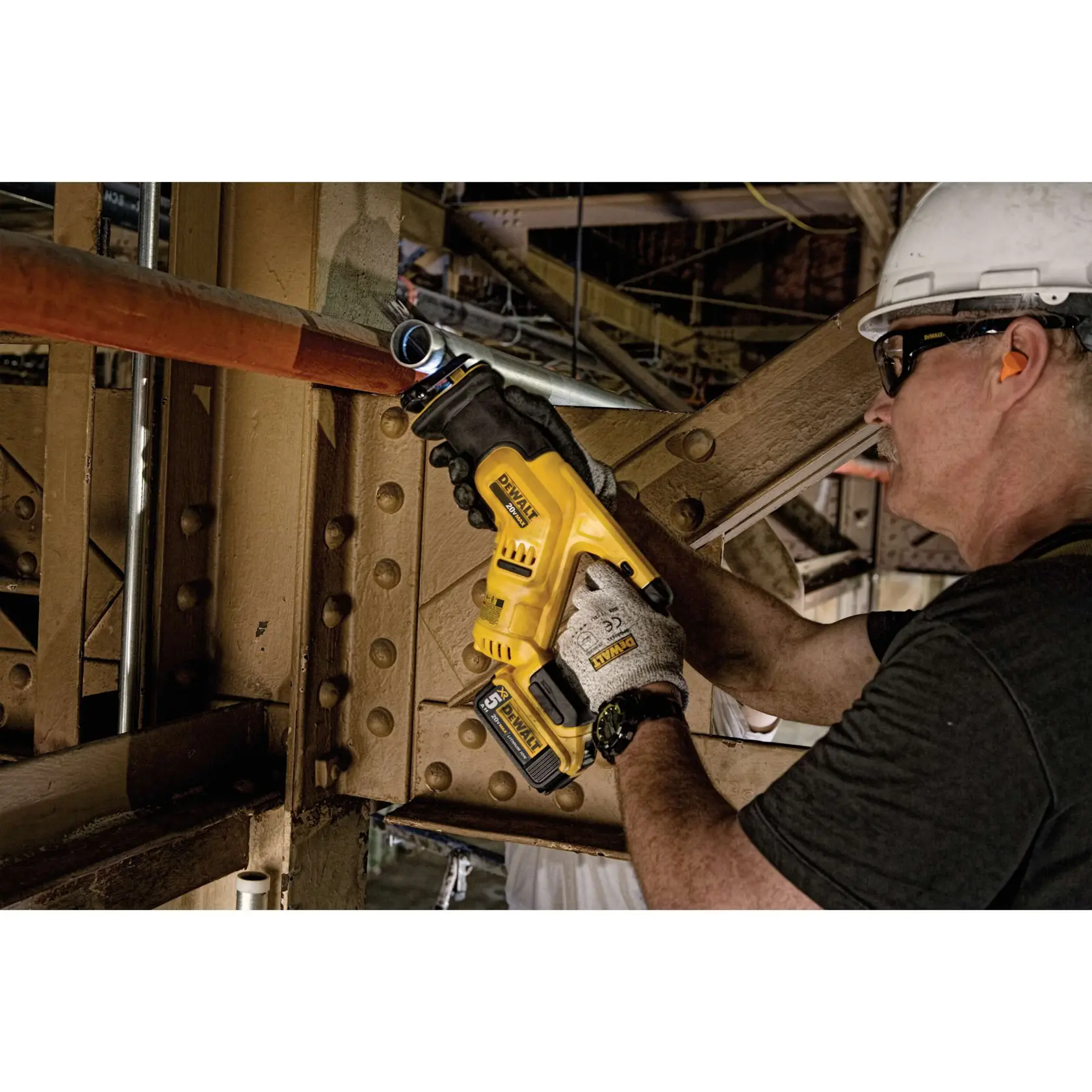 Cordless COMPACT Reciprocating Saw Kit being used by worker to cut metal pipe at worksite