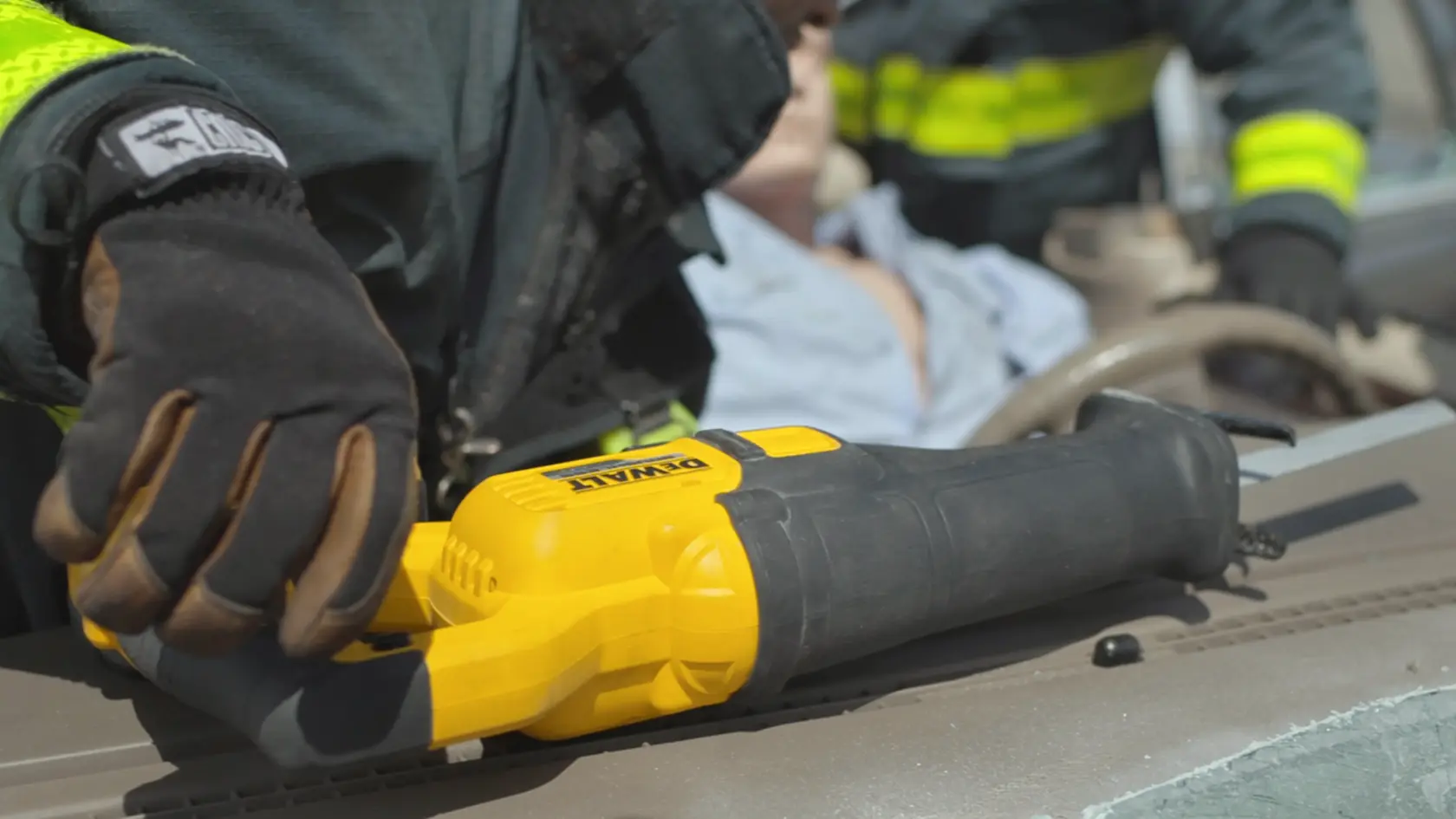 Application shot of DeWalt 60V Max Cordless Brushless Reciprocating Saw with Firefighter in background