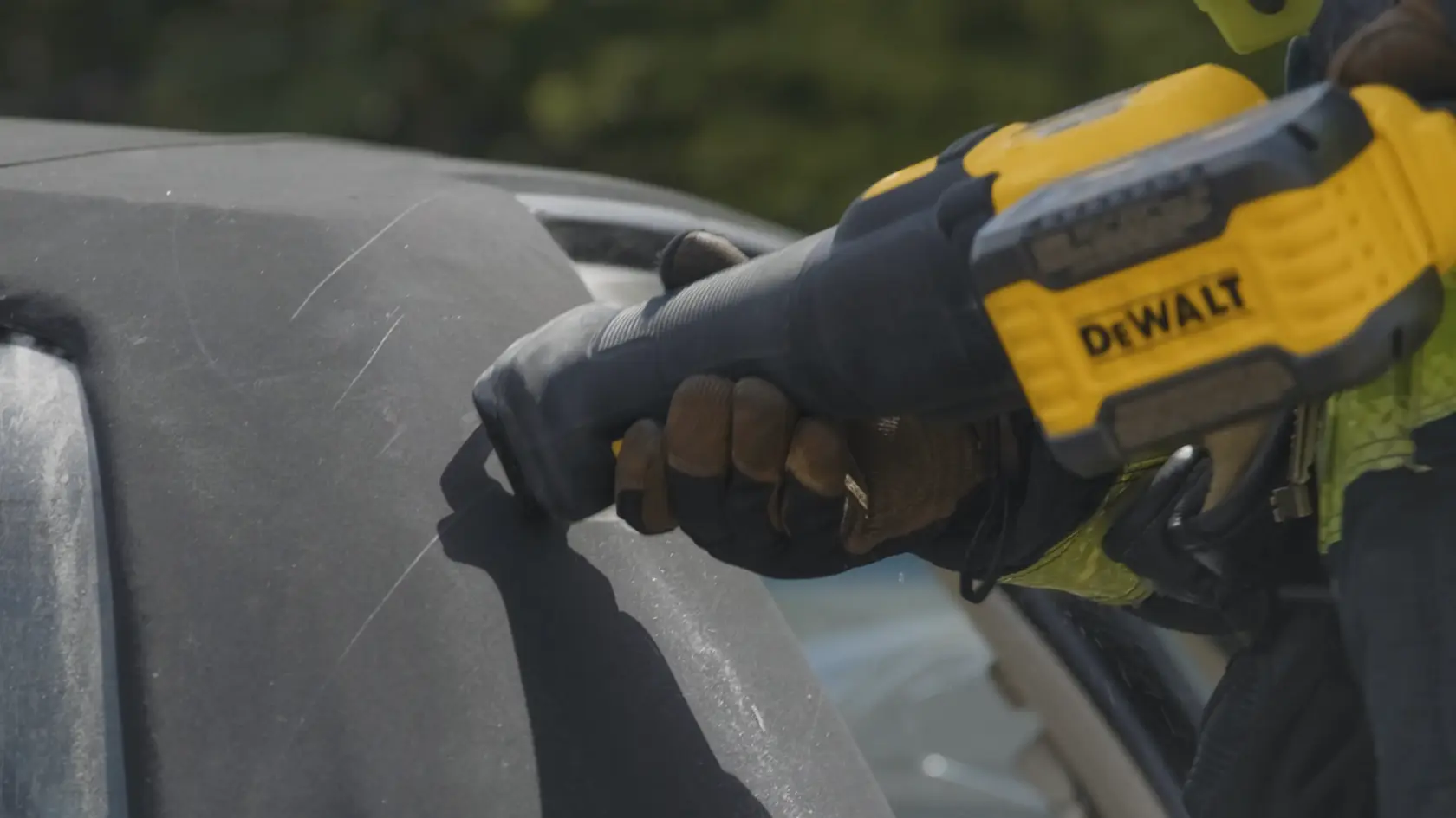Application shot of DeWalt 60V Max Cordless Brushless Reciprocating Saw being used saw into car