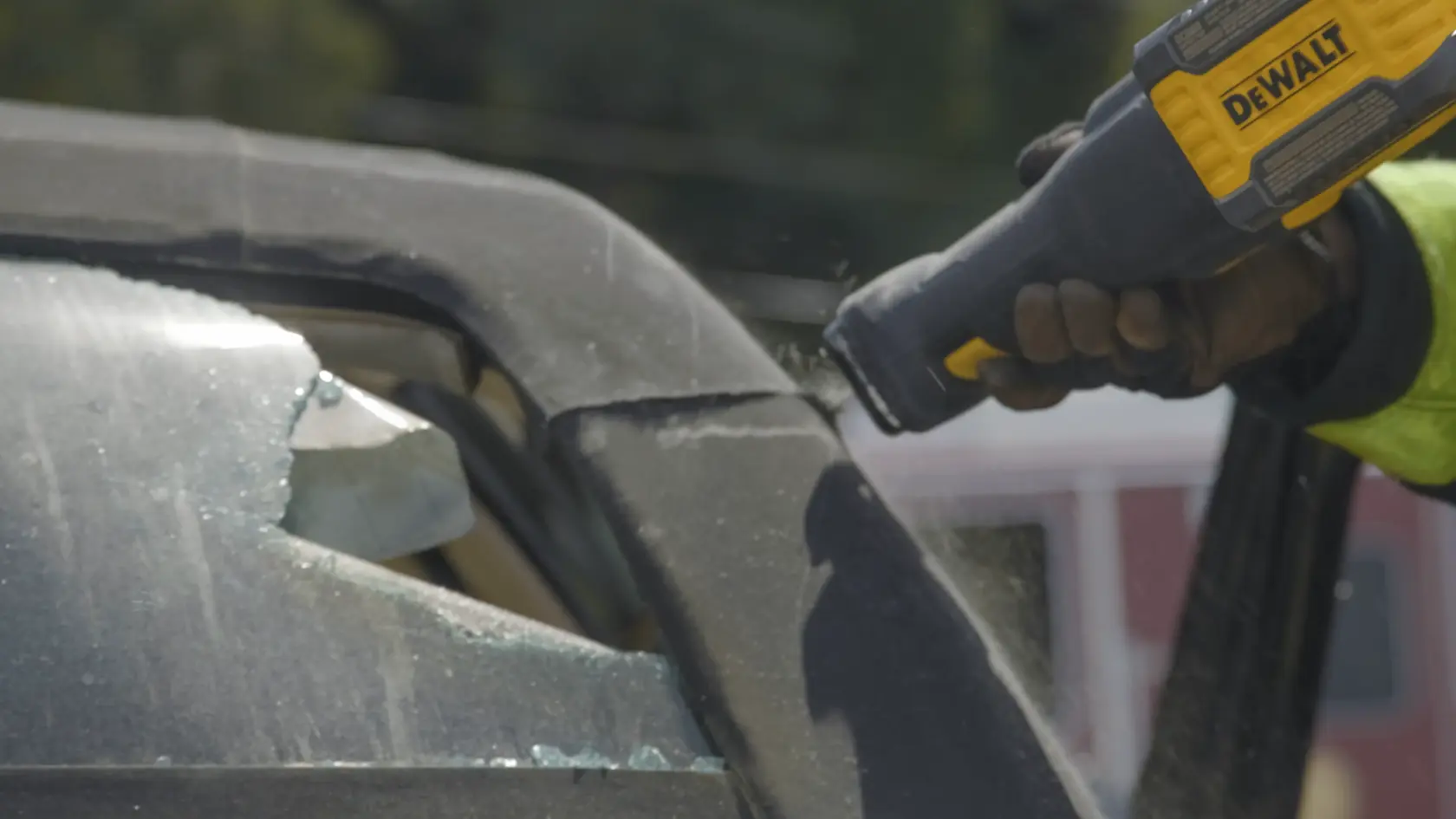 Application shot of DeWalt 60V Max Cordless Brushless Reciprocating Saw being used saw into car