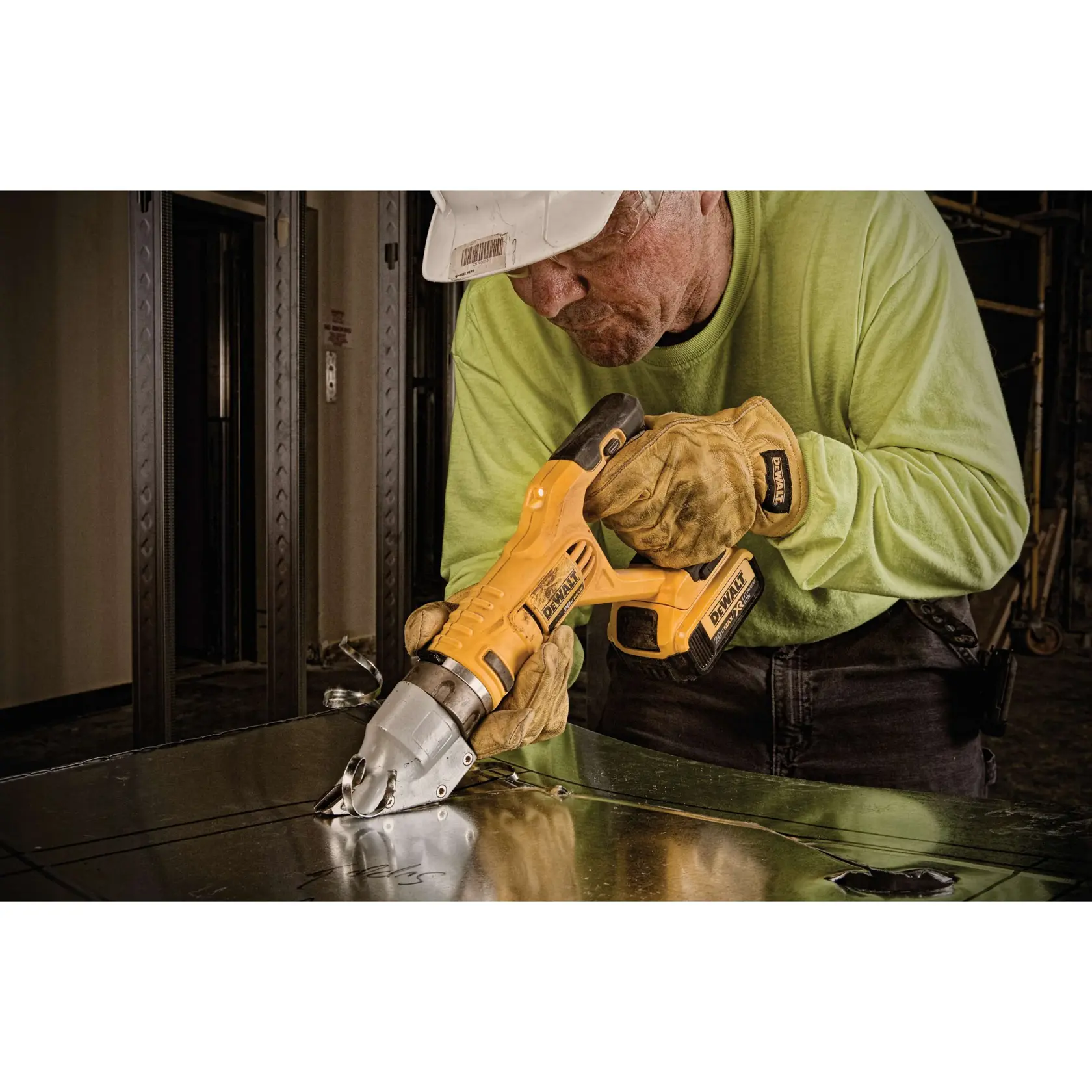 Swivel head shear being used on metal sheet.