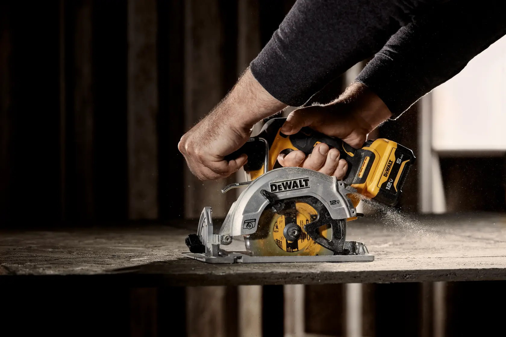 Xtreme 12 volt 5 and three eighths inch brushless cordless circular saw tool being used to cut wood.