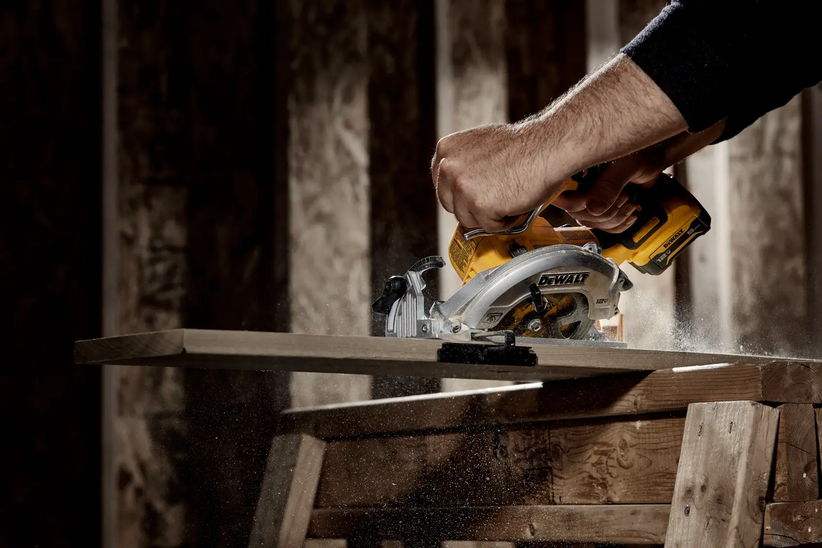 Xtreme 12 volt 5 and three eighths inch brushless cordless circular saw tool being used to cut wood.