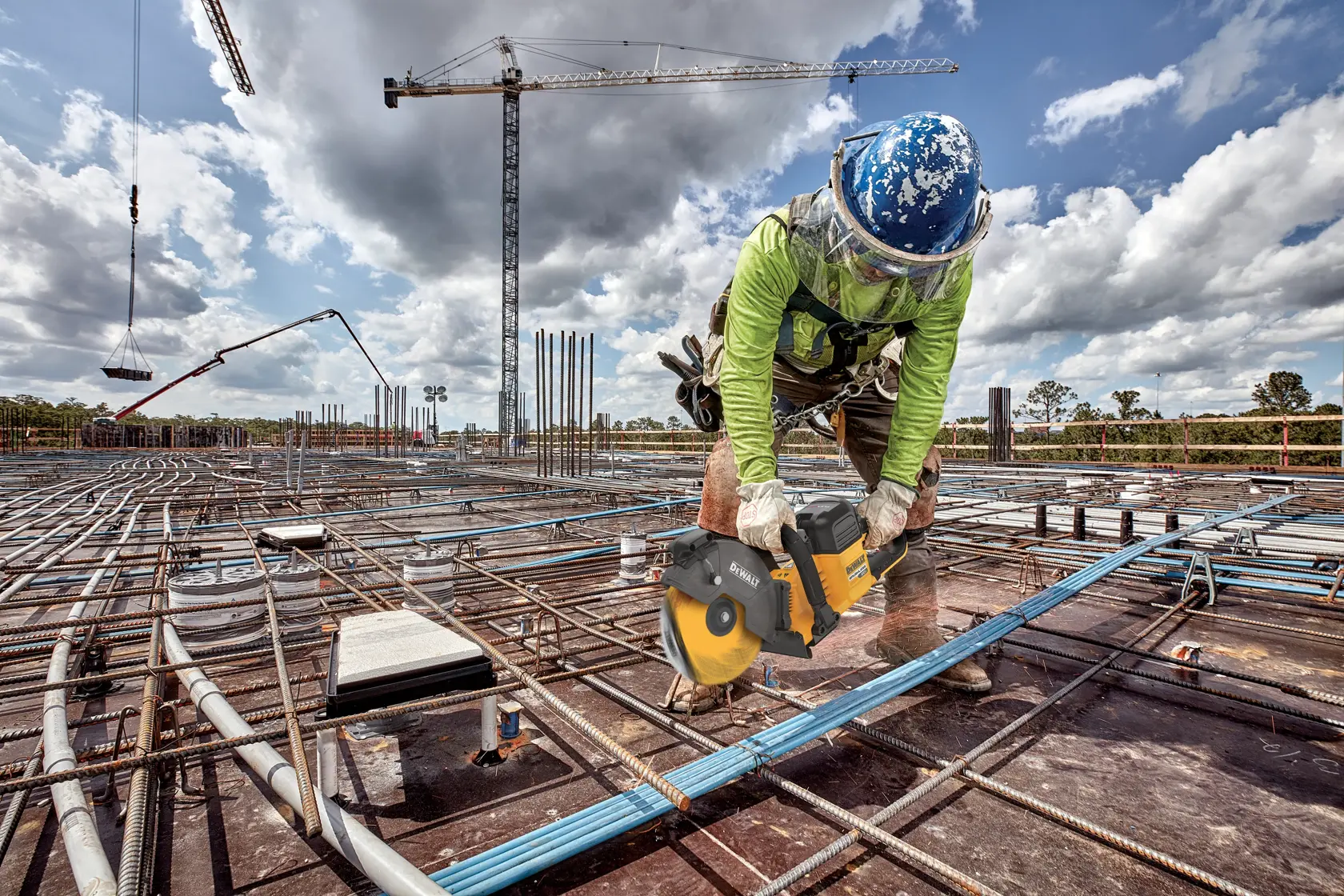 Application image of DEWALT DCS692 cutting into rebar on the rooftop of a building