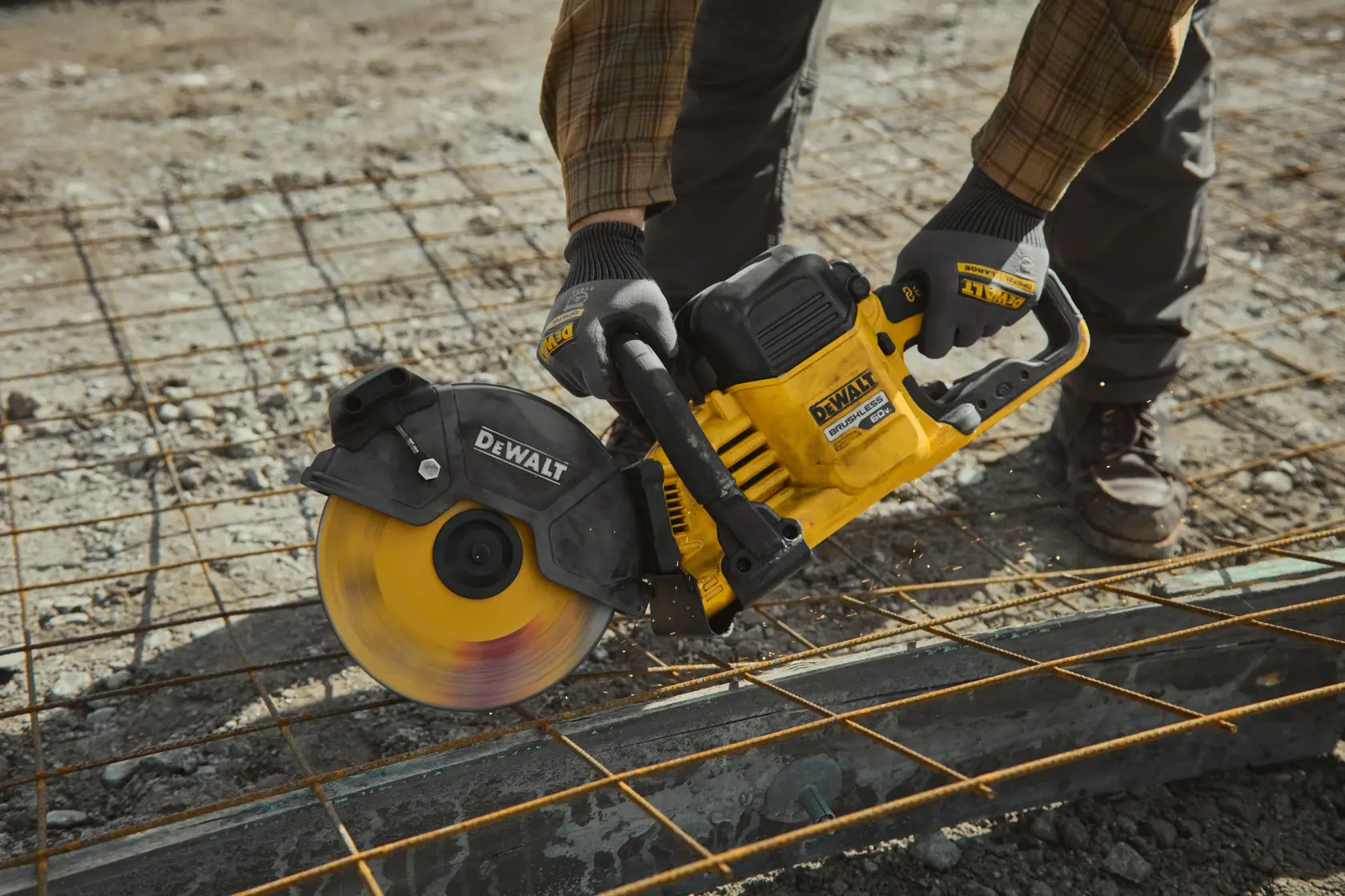 DEWALT 60V MAX* cut-off saw cutting through rebar on the ground