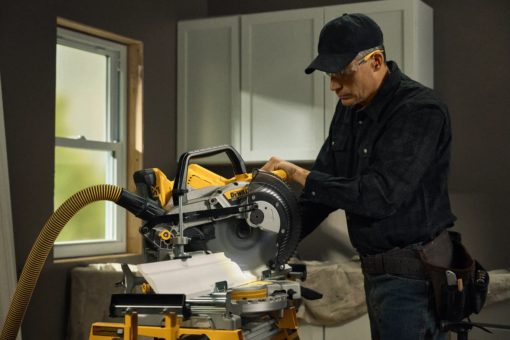 Talent cutting a piece of material with the 20V MAX* XR® 10in. Double Bevel Sliding Miter Saw 