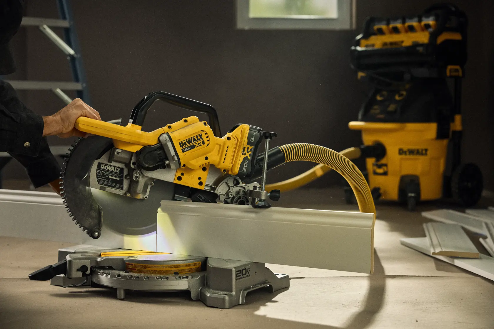 Talent cutting a piece of material with the 20V MAX* XR® 10in. Double Bevel Sliding Miter Saw 