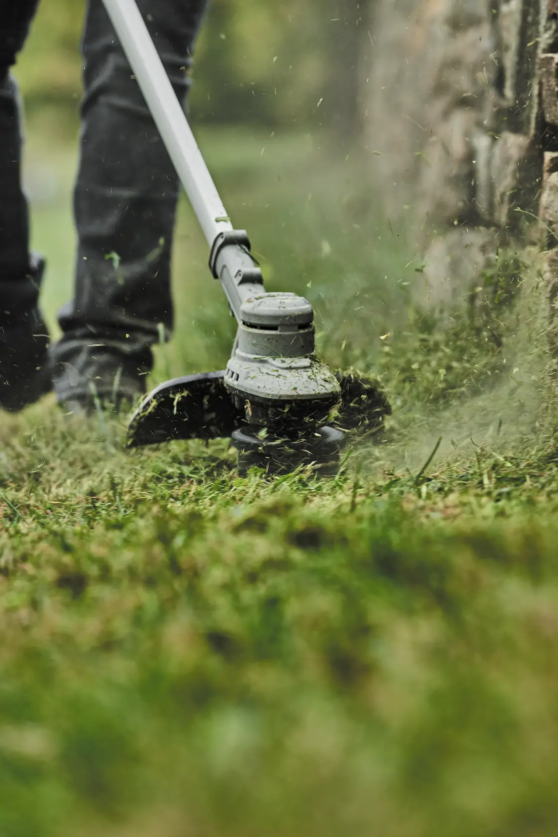 Folding String Trimmer being used by a person.