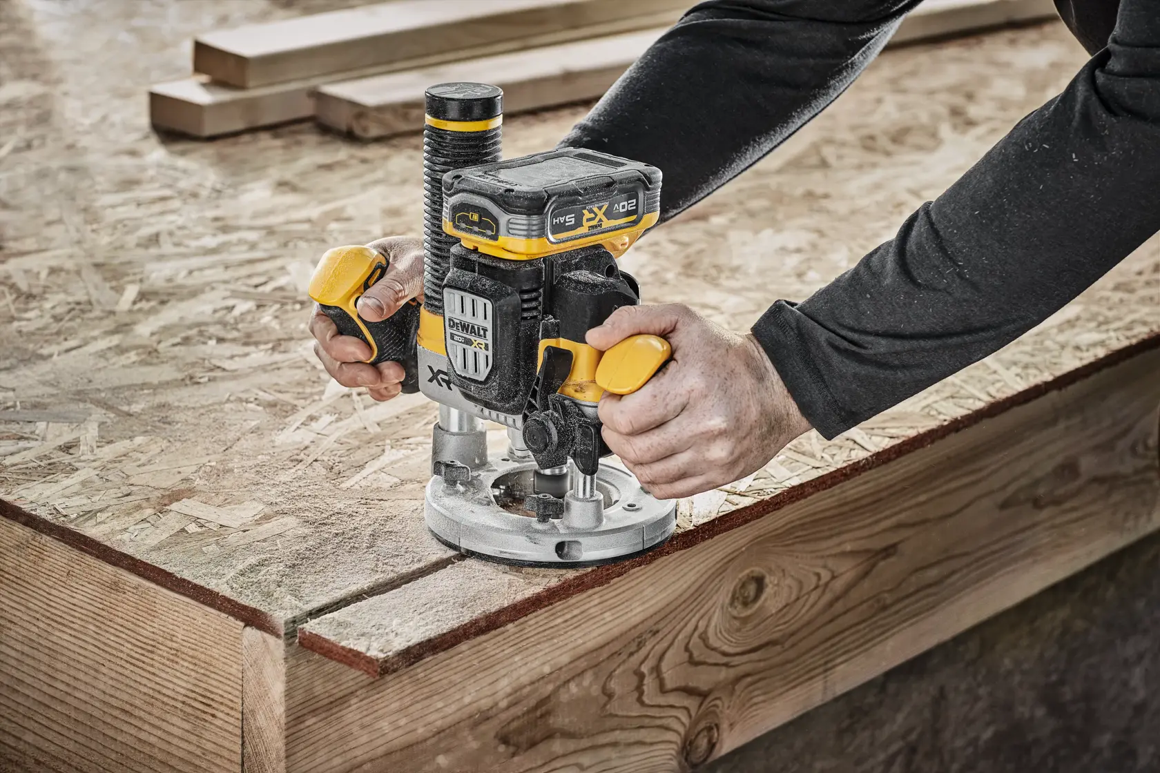 DEWALT XR 20V MAX* Plunge router with 20V MAX* XR 5 ah battery on wood surface in use