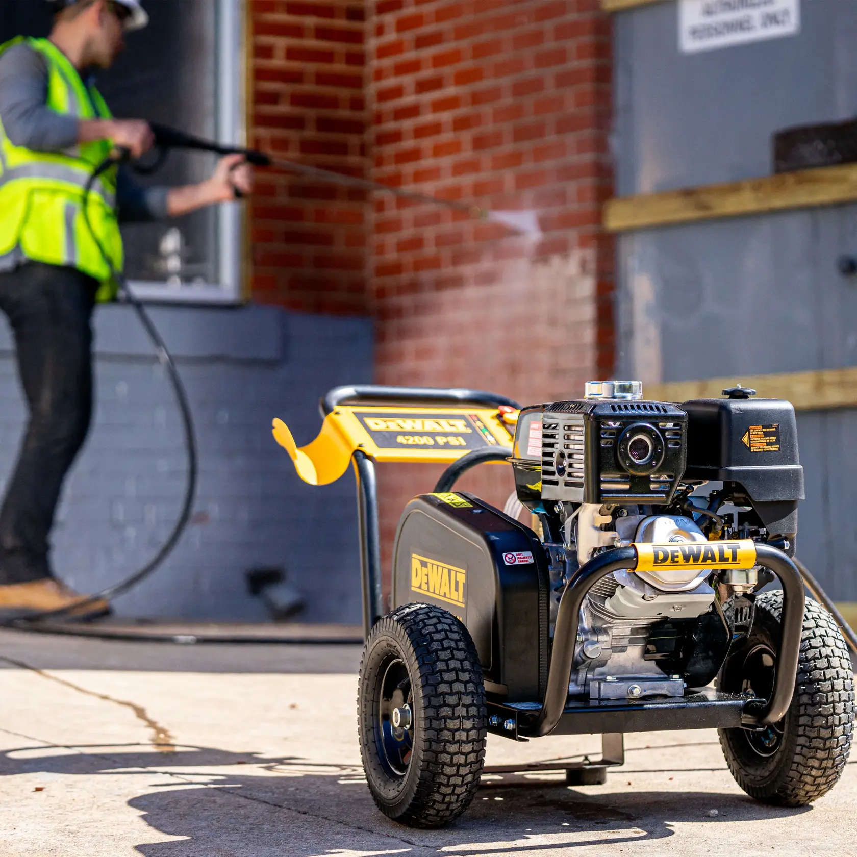 AAA Triplex Plunger Pump Cold Water Professional Gas Pressure Washer in being used on brick wall.