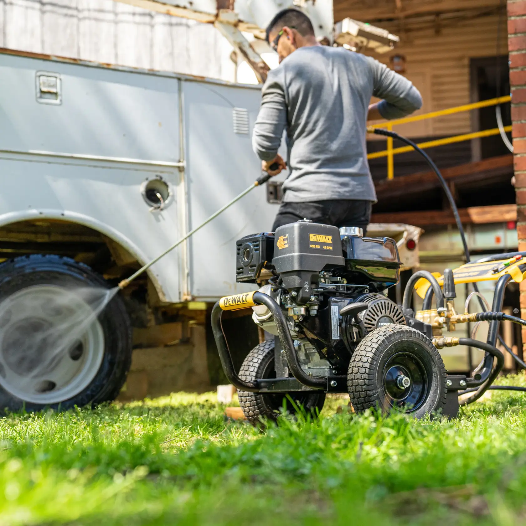 GPM HONDA cold water, gas pressure washer with a AAA Triplex plunger pump being used by a person