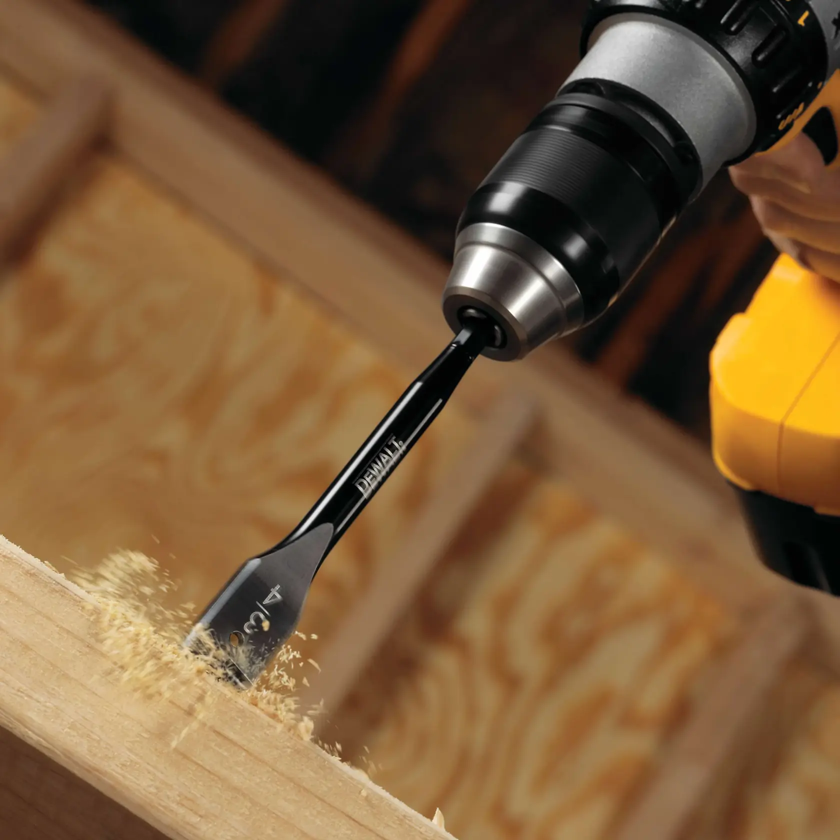 28.5 millimeters spade bit attached to a drill and drilling into wood.