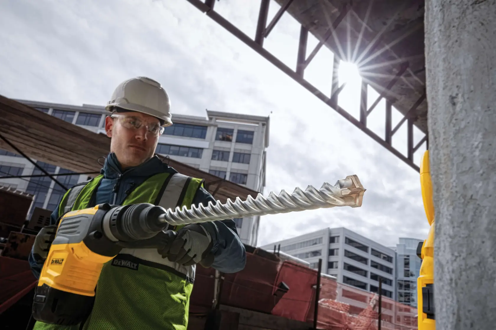 SDS Max High Impact Carbide 4 Cutter Drill Bit ready to be used by worker at outdoor work site.