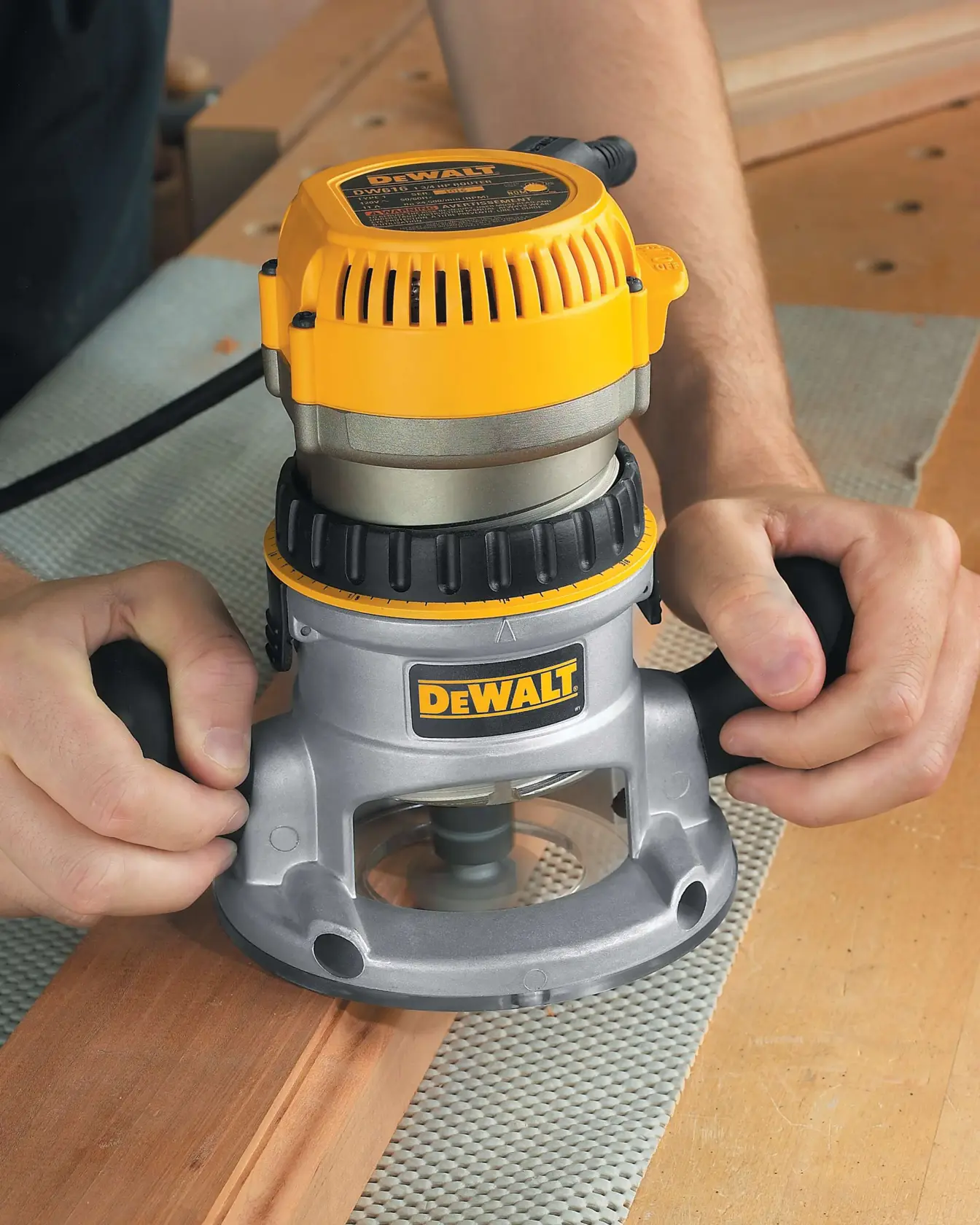 One and three quarters HP Fixed Base Router being used on a wooden surface.