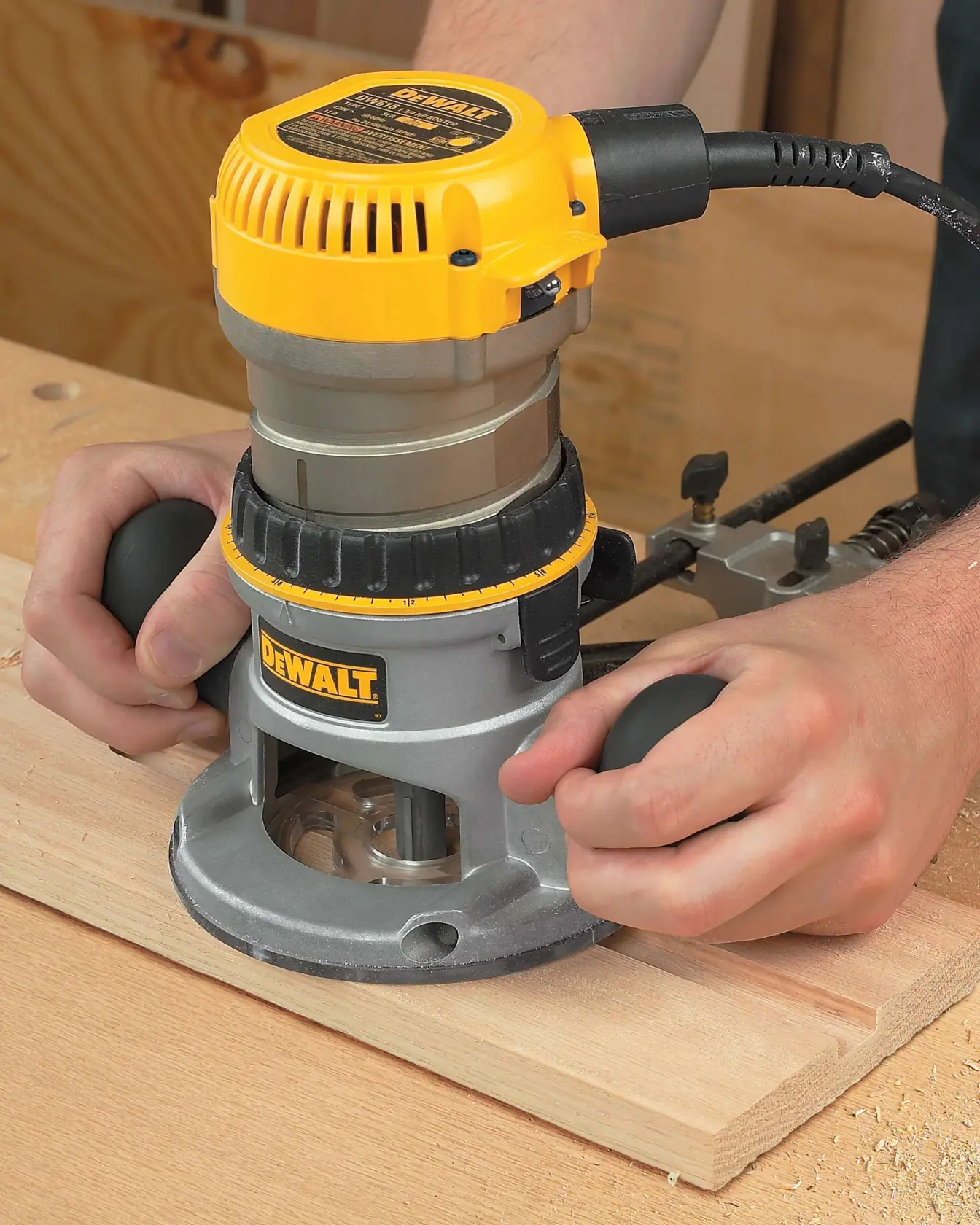 One and three quarters HP Fixed Base Router being used on a wooden plank.