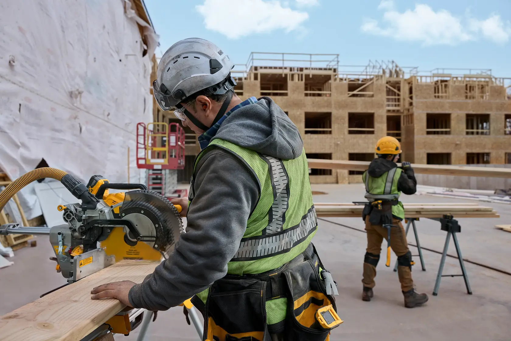 user cutting wood with miter saw