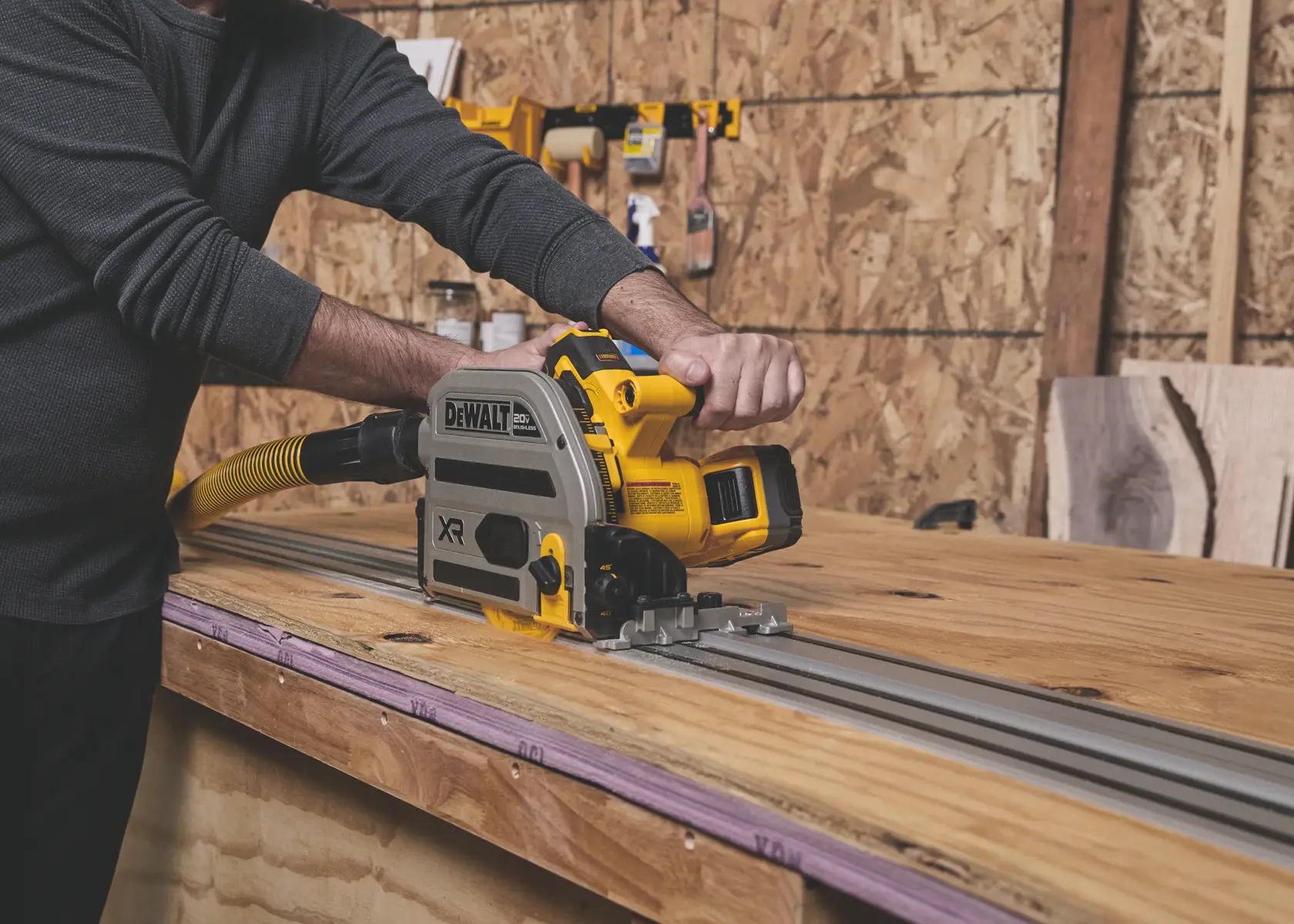 DEWALT track saw cutting wood, SKUs DWA261224TS, BSV520BRB. Tool on guide rail in workshop.