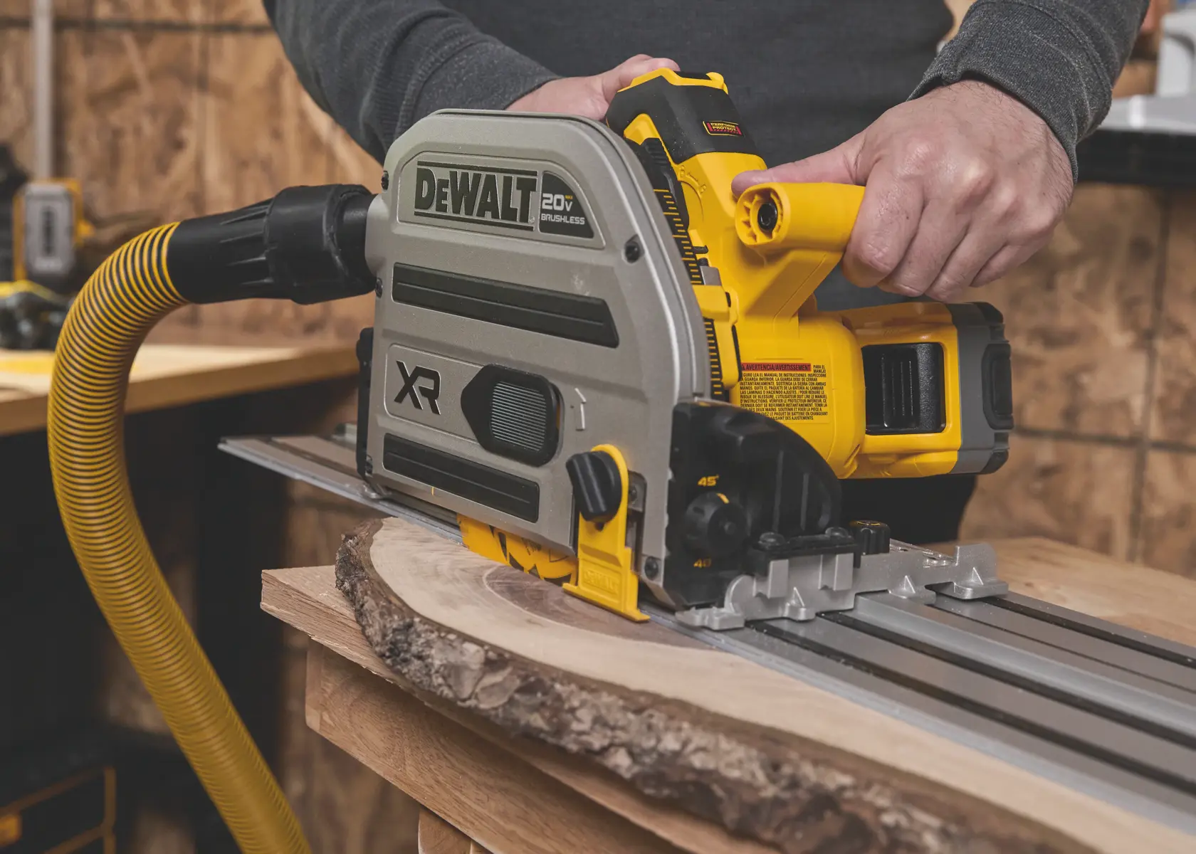 DEWALT saw in use, yellow hose attached. SKUs DWA261224TS, BSV520BRB. Photography product.