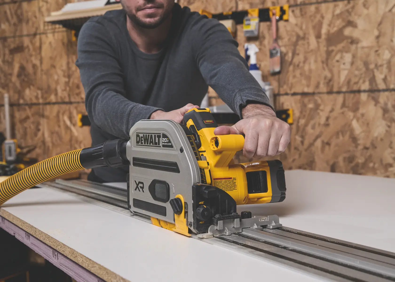 DEWALT track saw in use, SKUs BSV520BRB and DWA261252TS, photography category, on work table.