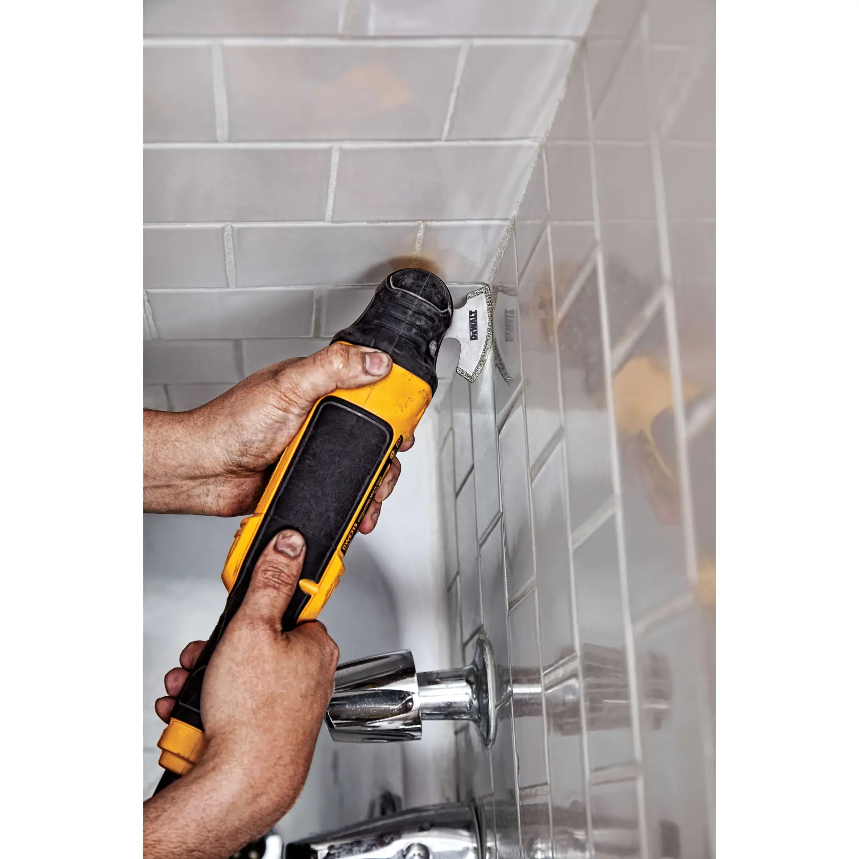 A personal using Diamond Swing Blade to remove ground from tiles in bathroom.