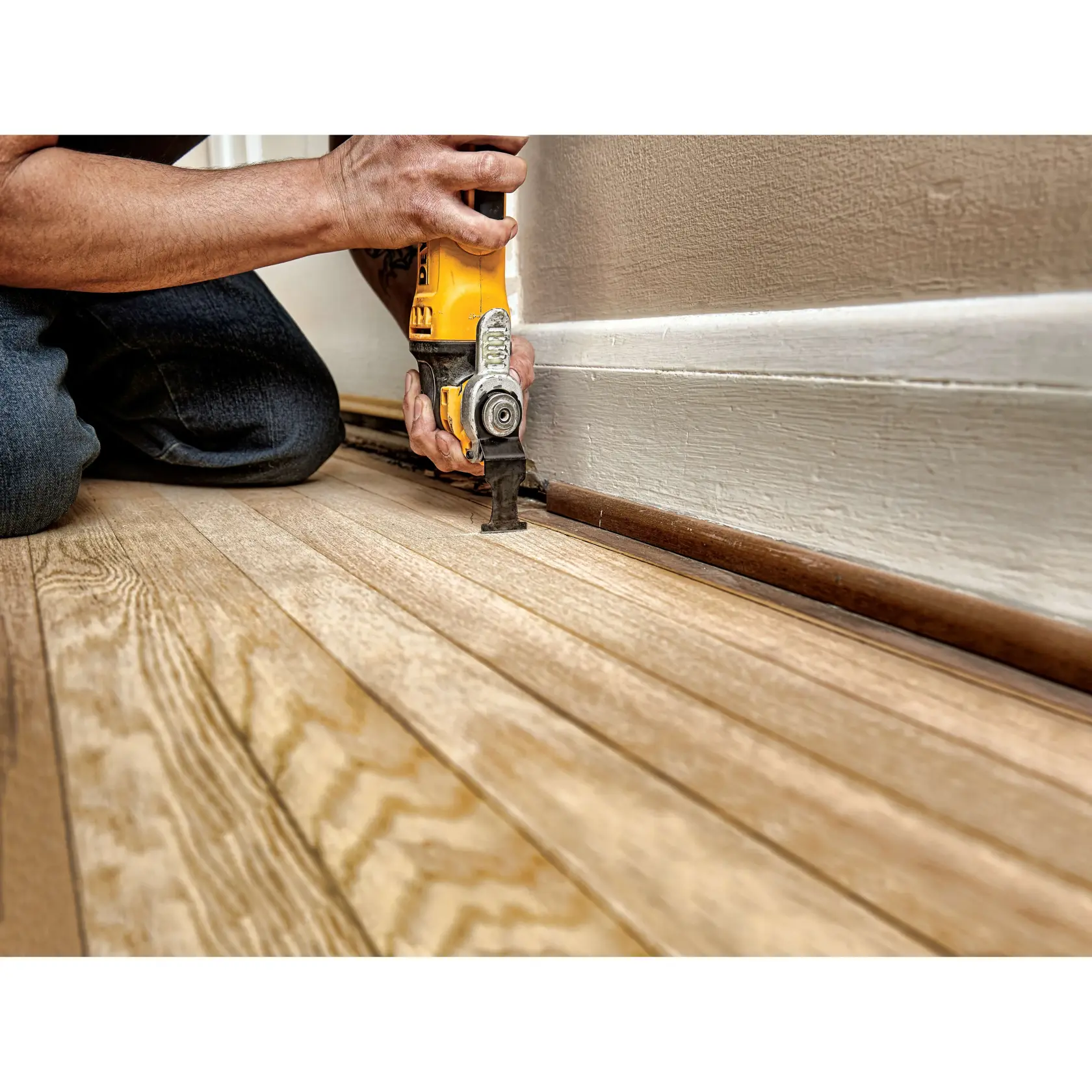 1 three eighth inch Carbide Blade being used on floor skirting by person.