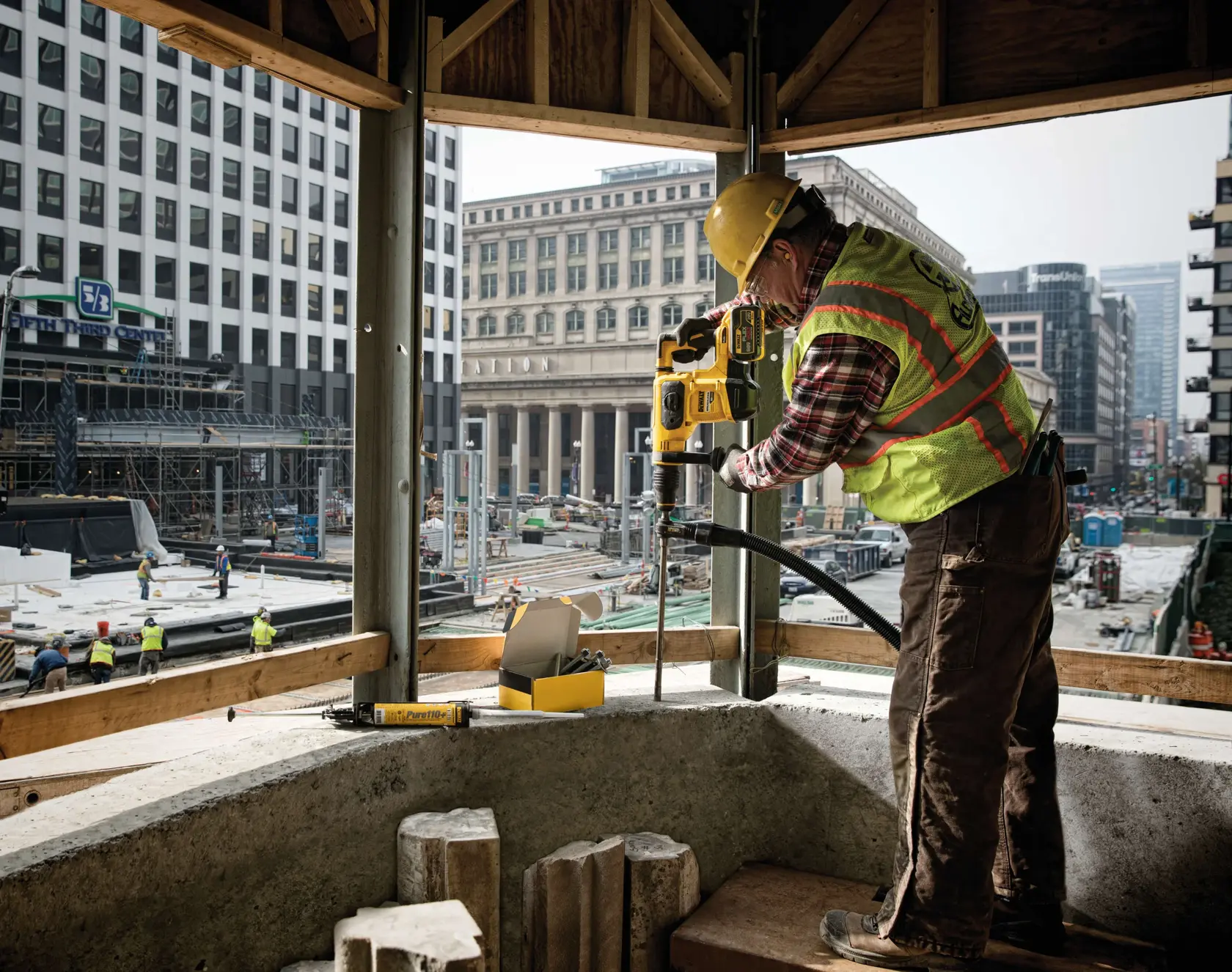 SDS Max Hollow Bits being used at an indoor construction site by workman with city view from windows.
