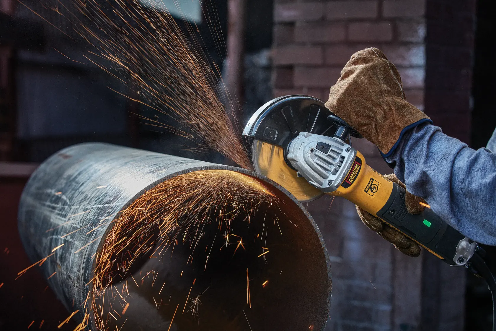 4 and half inch HP Cut off Wheel being used to cut of wide metal tube by person.