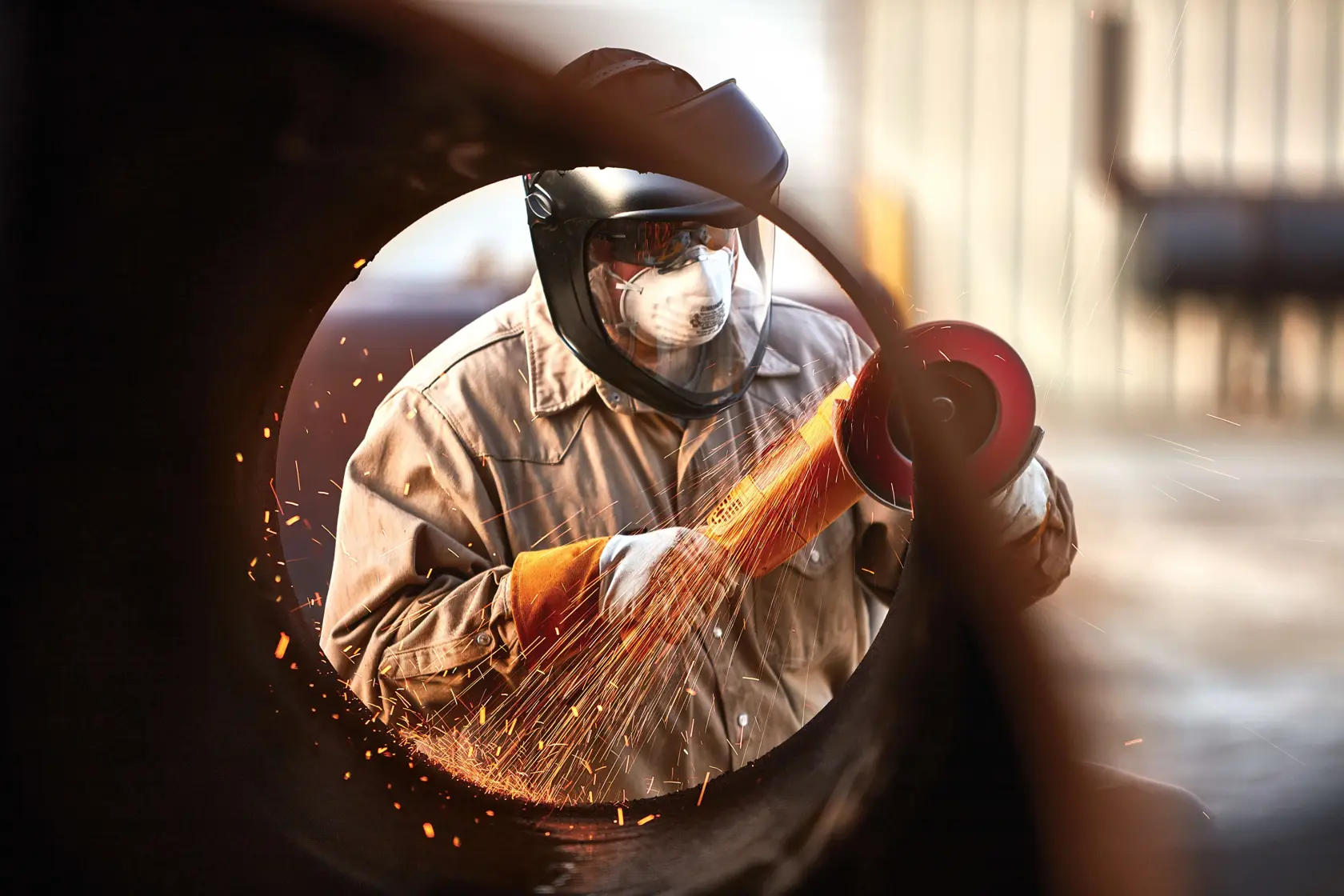 X P CERAMIC FLAP DISC TYPE 27 being used by worker to weld pipe.