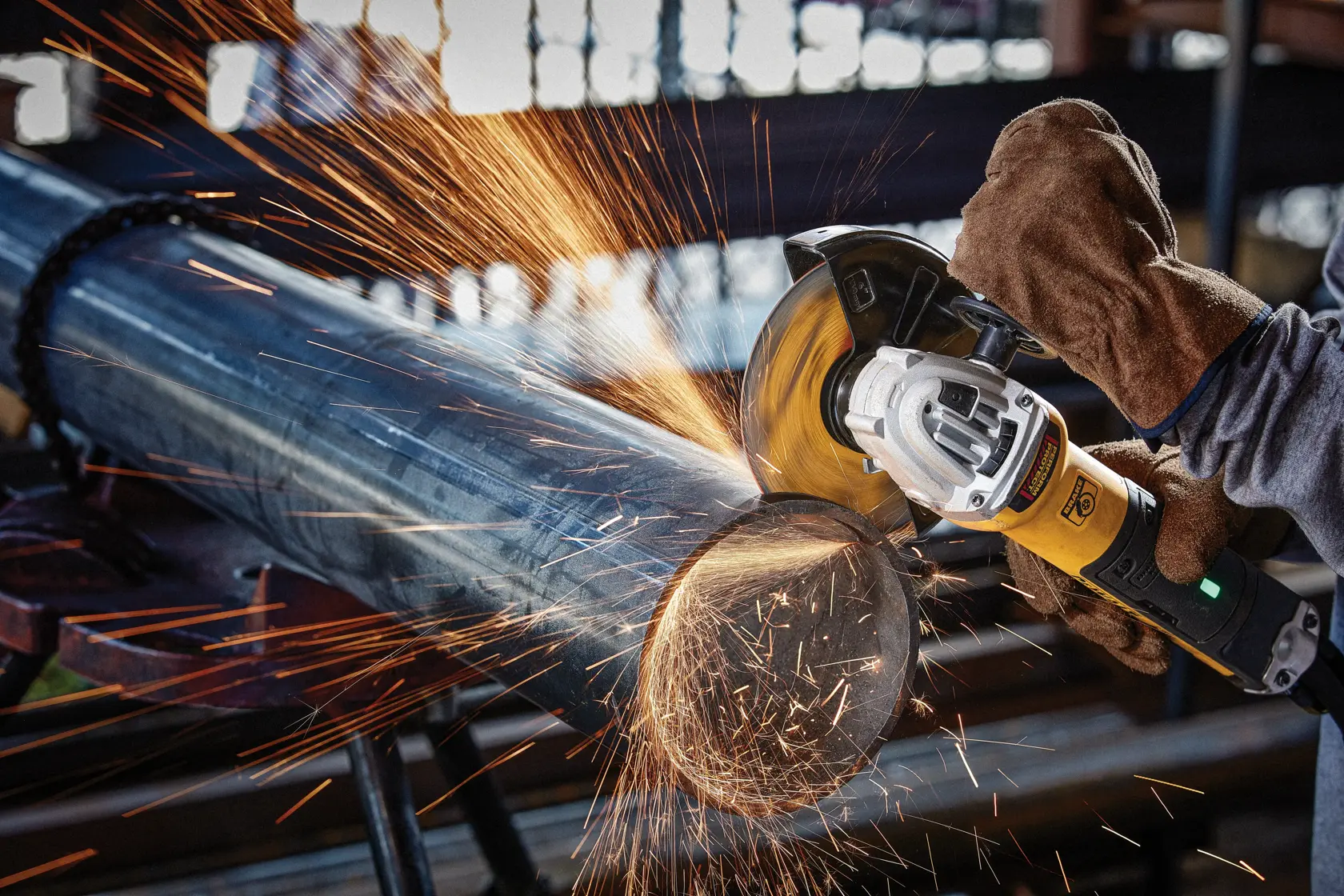 4 and half inch HP Cut off Wheel being used to cut of metal tube by person.