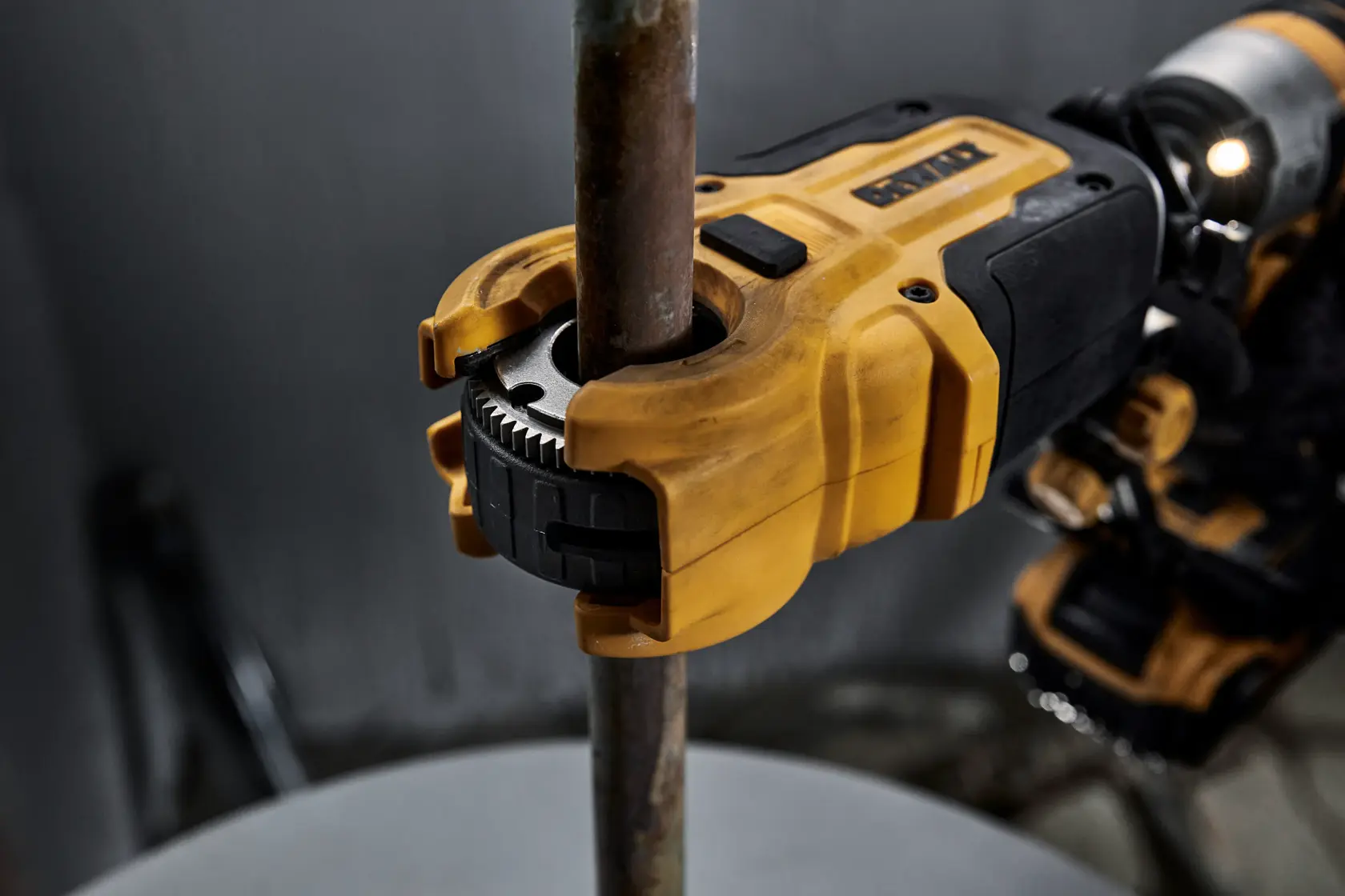 Close up of DEWALT IMPACT CONNECT Copper Cutter attachment on Impact Driver to cut copper pipe.