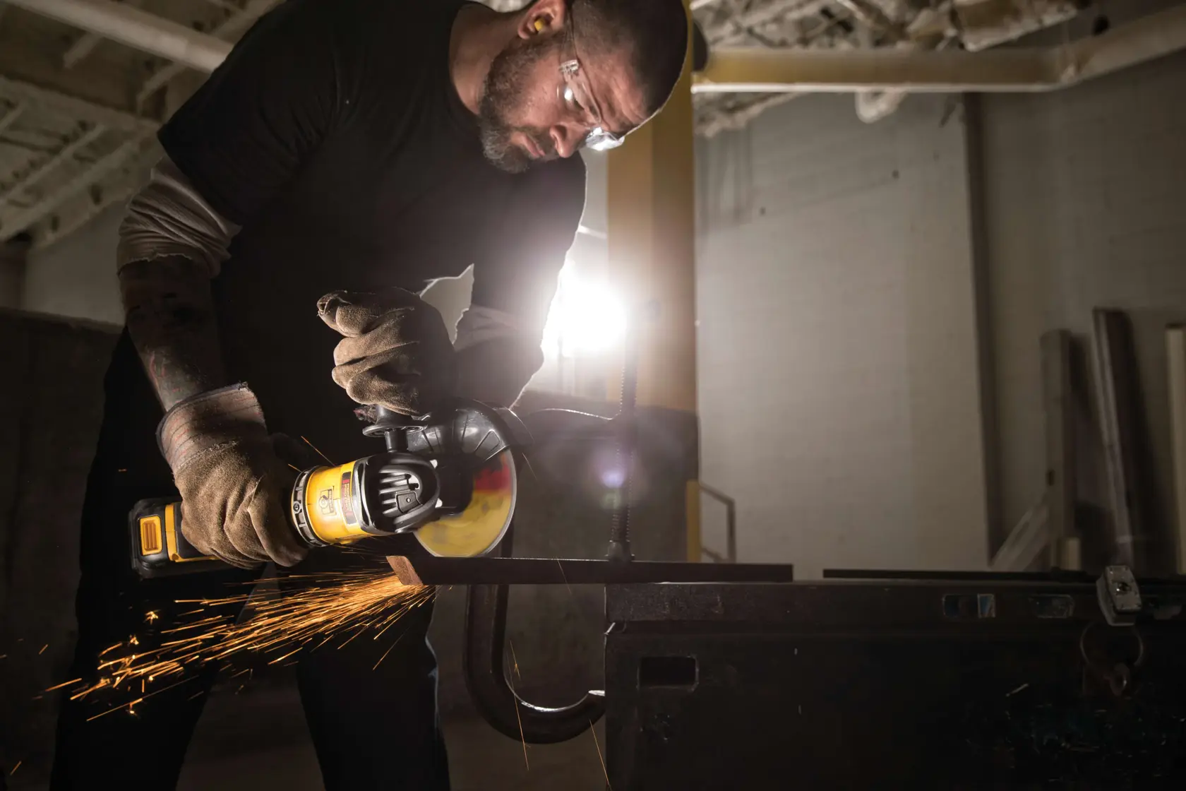 FLEXVOLT METAL CUTTING WHEELS TYPE 1 being used by worker to cut metal bar at job site.